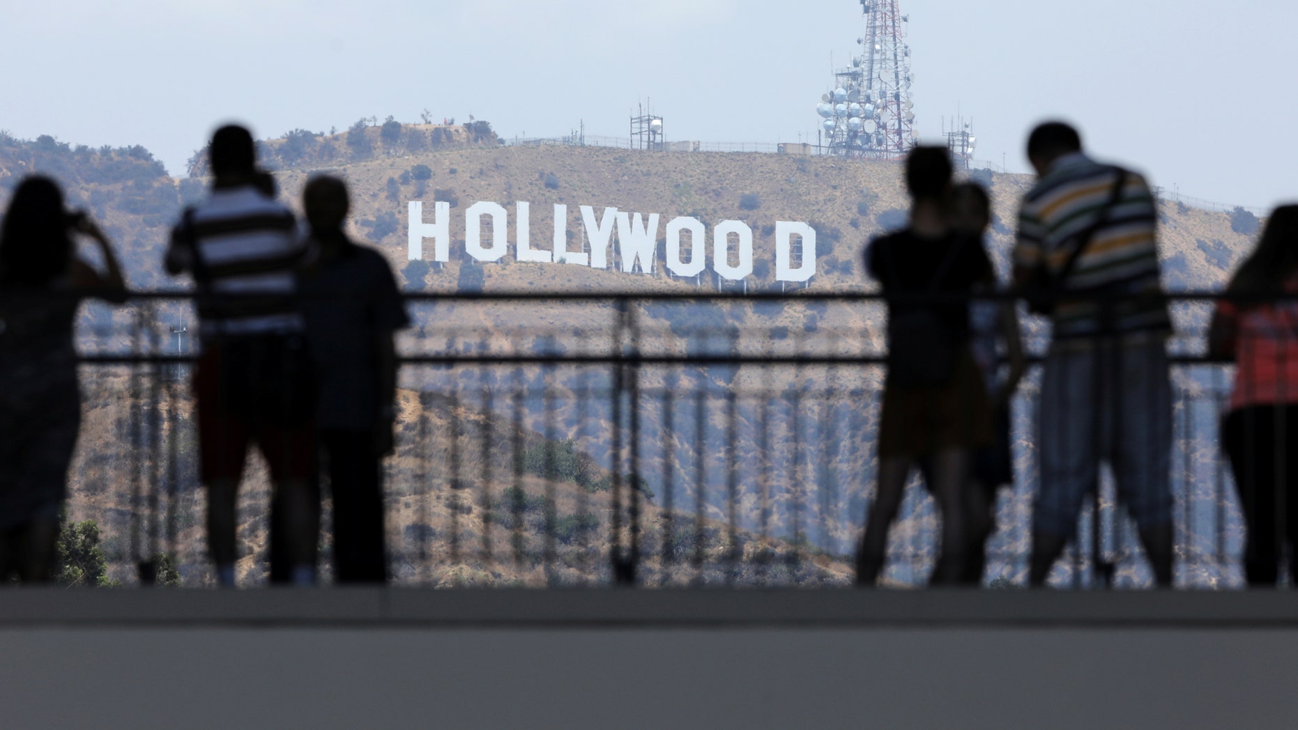 FILE -- Tourists take pictures of the Hollywood sign from a shopping complex along Hollywood Boulevard in Hollywood, California, August 3, 2017.