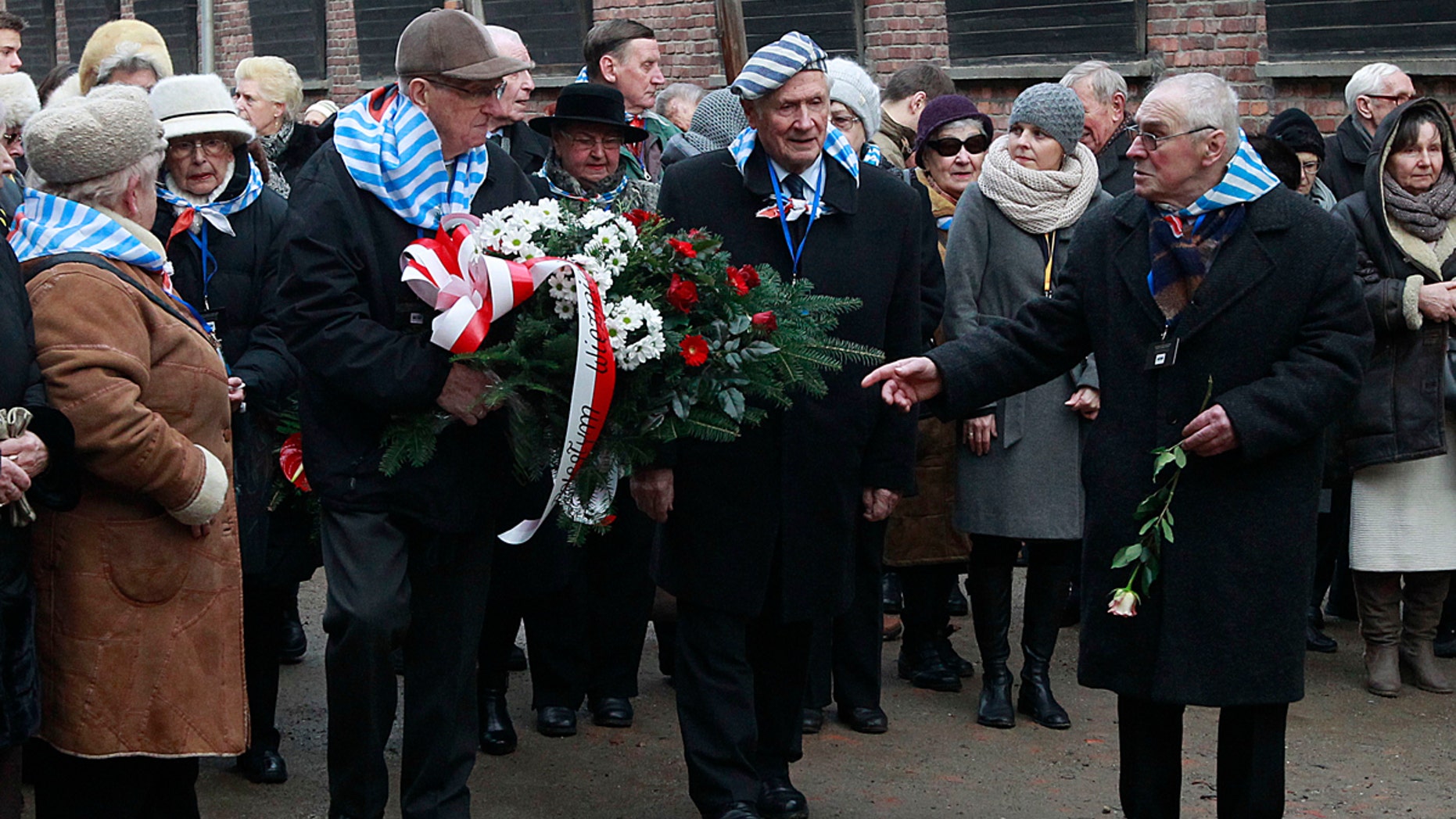 Holocaust survivors commemorate the people killed by the Nazis at the former Auschwitz Nazi death camp in Oswiecim, Poland, Wednesday, Jan. 27, 2016, the International Holocaust Remembrance Day that marks the liberation of the Auschwitz Nazi death camp on Jan. 27, 1945. (AP Photo/Czarek Sokolowski)