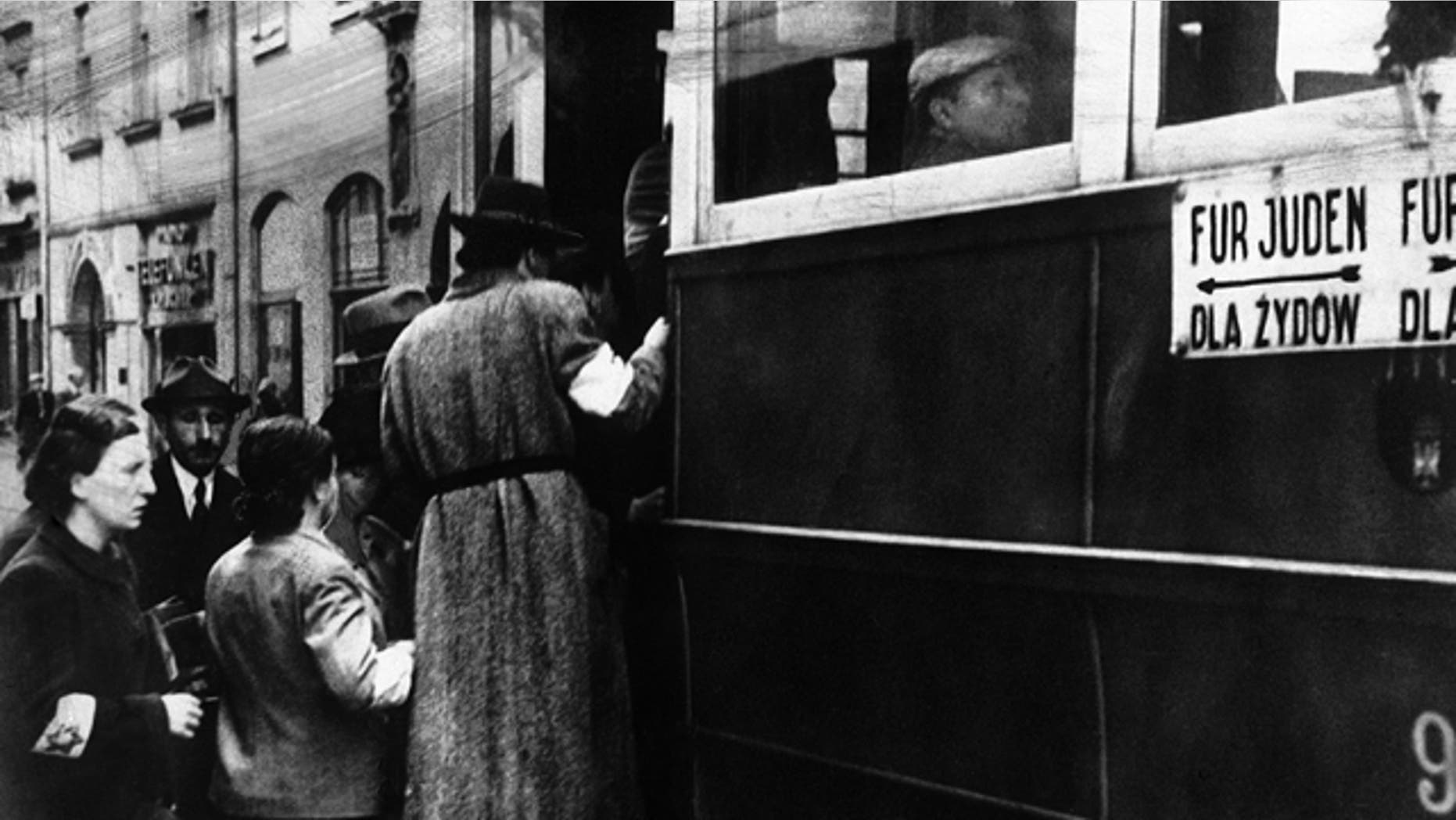 Feb. 17, 1941: FILE - This file photo shows a scene in the Warsaw Ghetto where Jews wearing white armlets bearing the Star of David board a tram marked with the words For Jews Only.