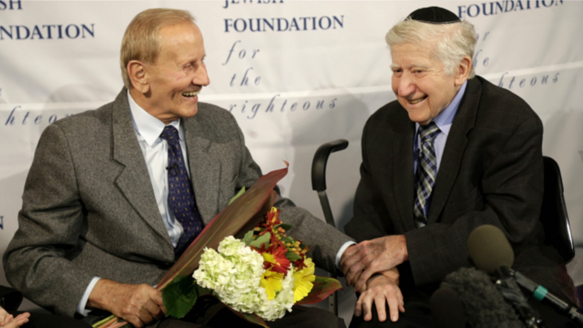 Nov. 27, 2013: Leon Gersten, right, and Czeslaw Polziec, of Poland, talk with the media after reuniting after 69 years in New York. Polziec's family hid the Gerstens, a Jewish family, from Nazi occupiers in their attic for two years during the Holocaust.