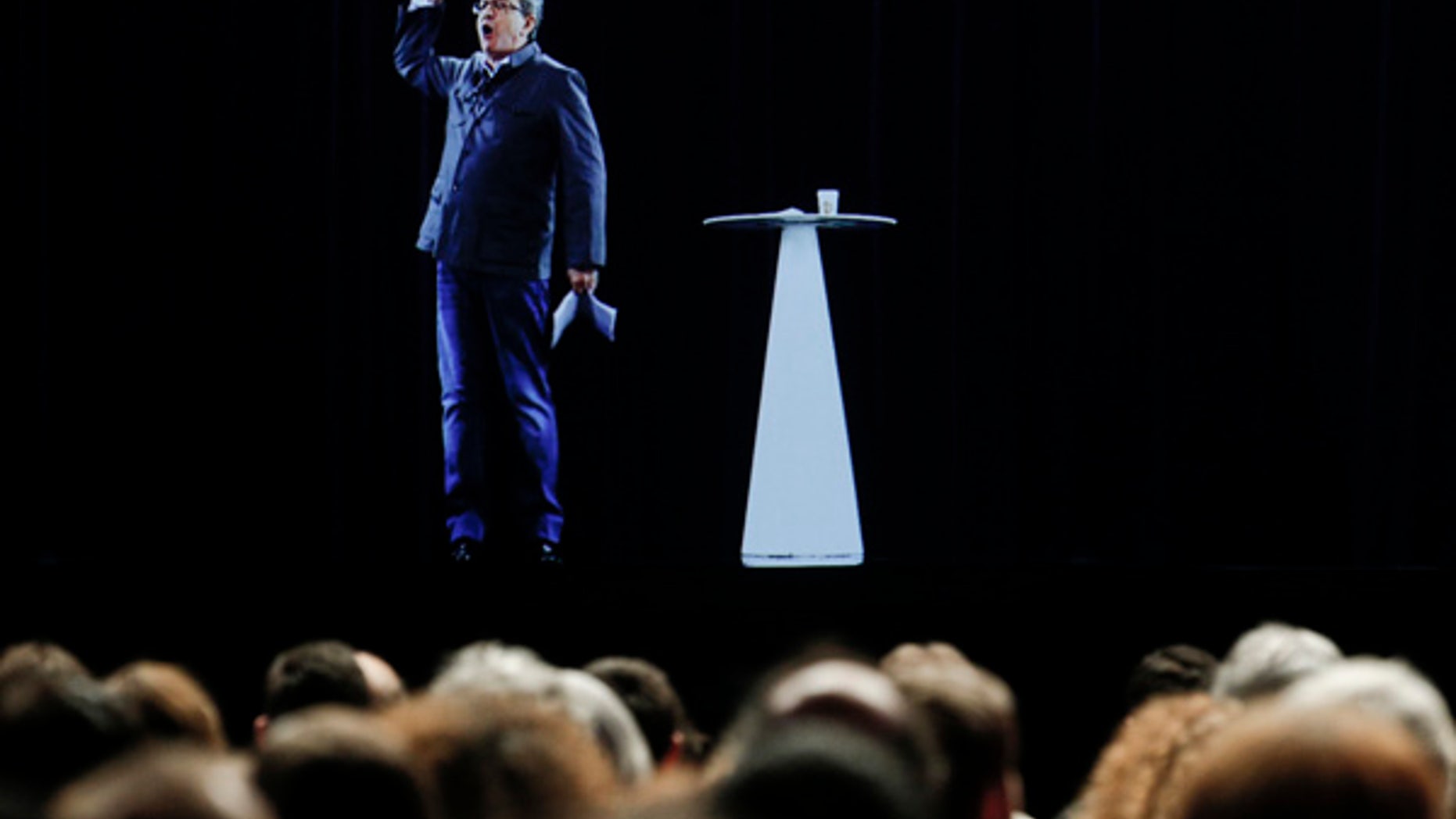The hologram of hard-left French presidential candidate Jean-Luc Melenchon speaks to supporters who are gathered in Saint-Denis, near Paris.