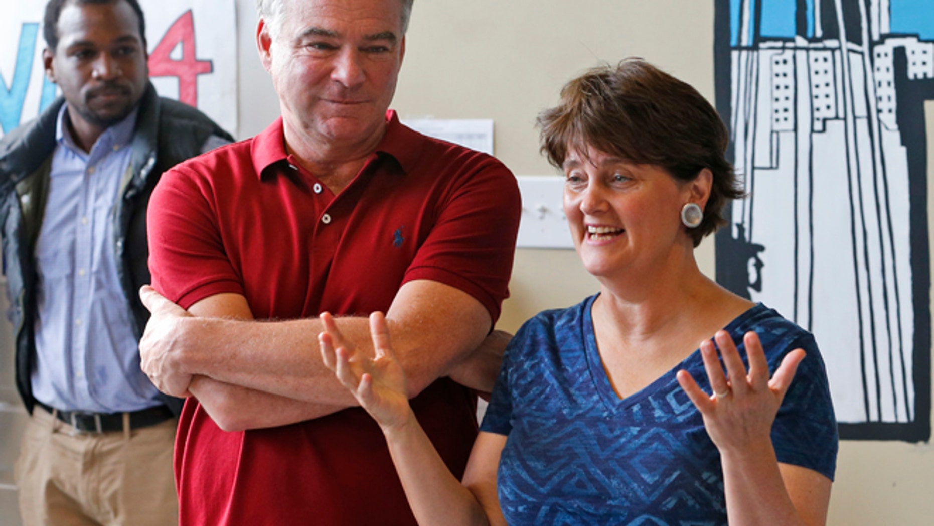 Aug. 1, 2016: Democratic vice presidential candidate Tim Kaine listens as his wife Anne Holton speaks at a campaign office in Richmond, Va.