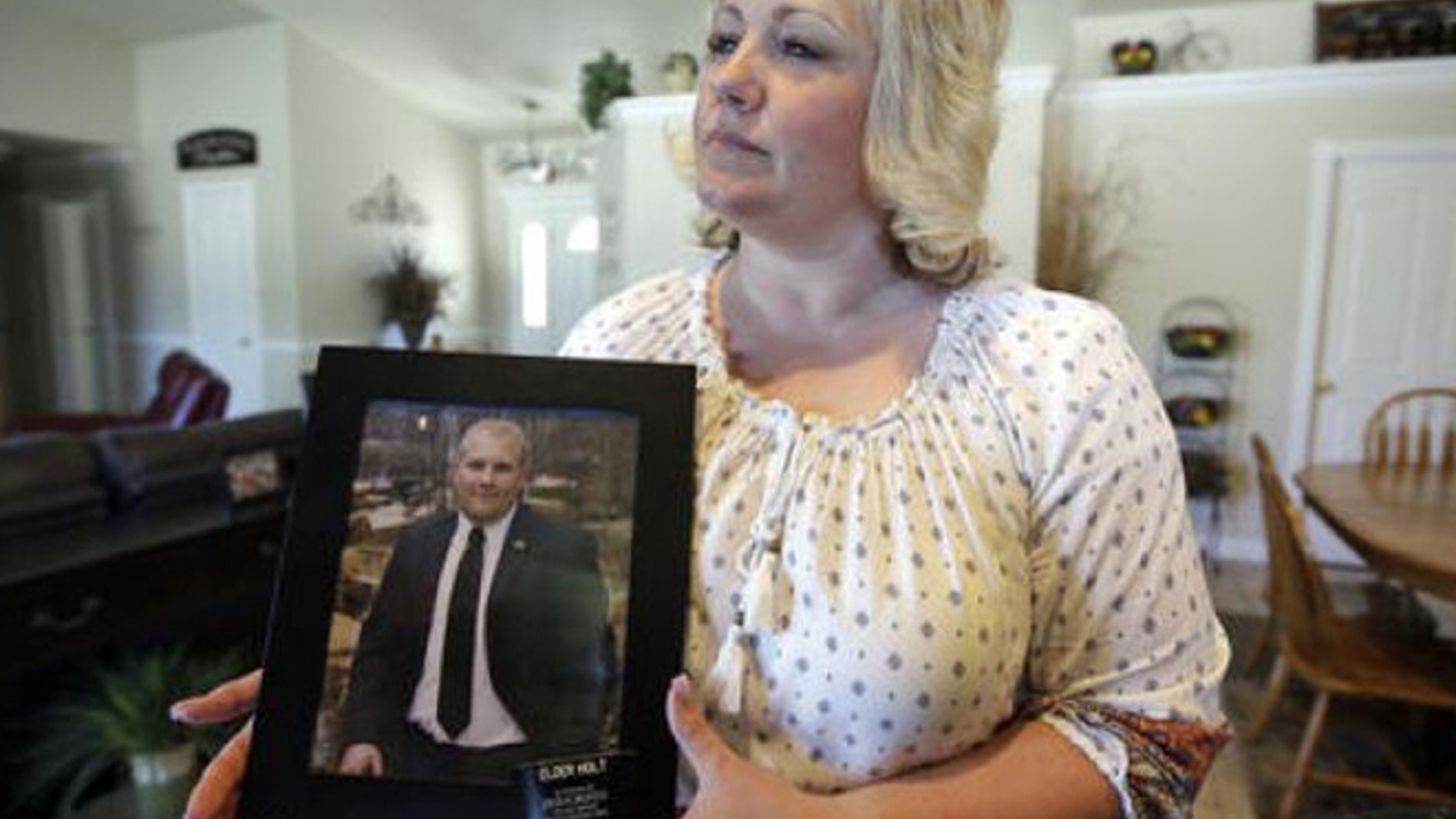 FILE - In this July 30, 2016, file photo, Laurie Holt, the mother of Josh Holt, an American jailed in Venezuela, cries during a rally at the Utah State Capitol, in Salt Lake City.