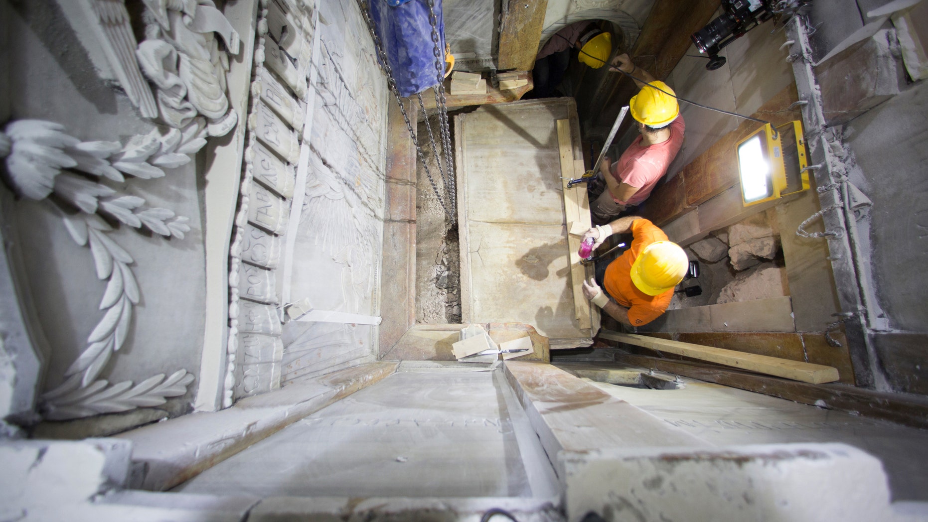 This Wednesday Oct. 26, 2016 shows the moment workers remove the top marble layer of the tomb in Jerusalem's Church of Holy Sepulchre. (Dusan Vranic/National Geographic via AP)