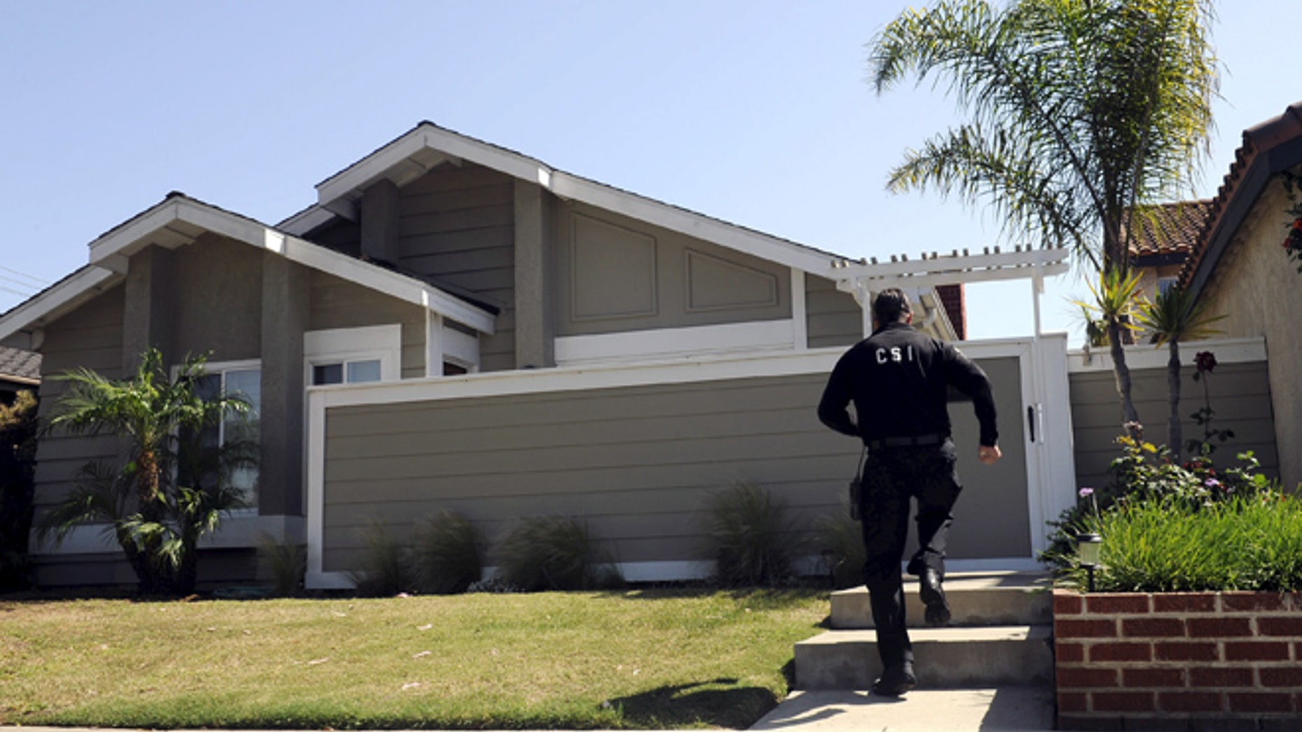 FILE: A Huntington Beach police Crime Scene Investigator is shown at the family home of Denise Huskins in Huntington Beach, California