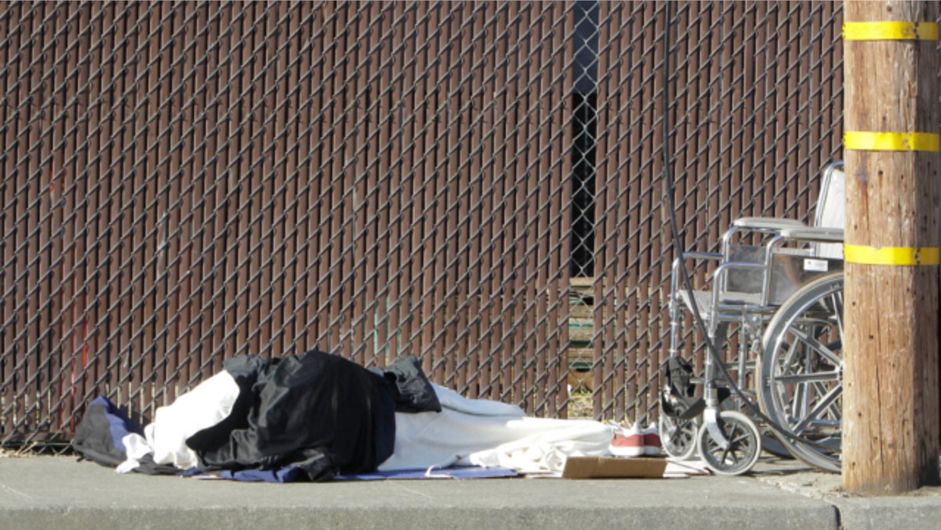 April 23, 2013: A homeless person sleeps on a sidewalk in Sacramento, Calif.