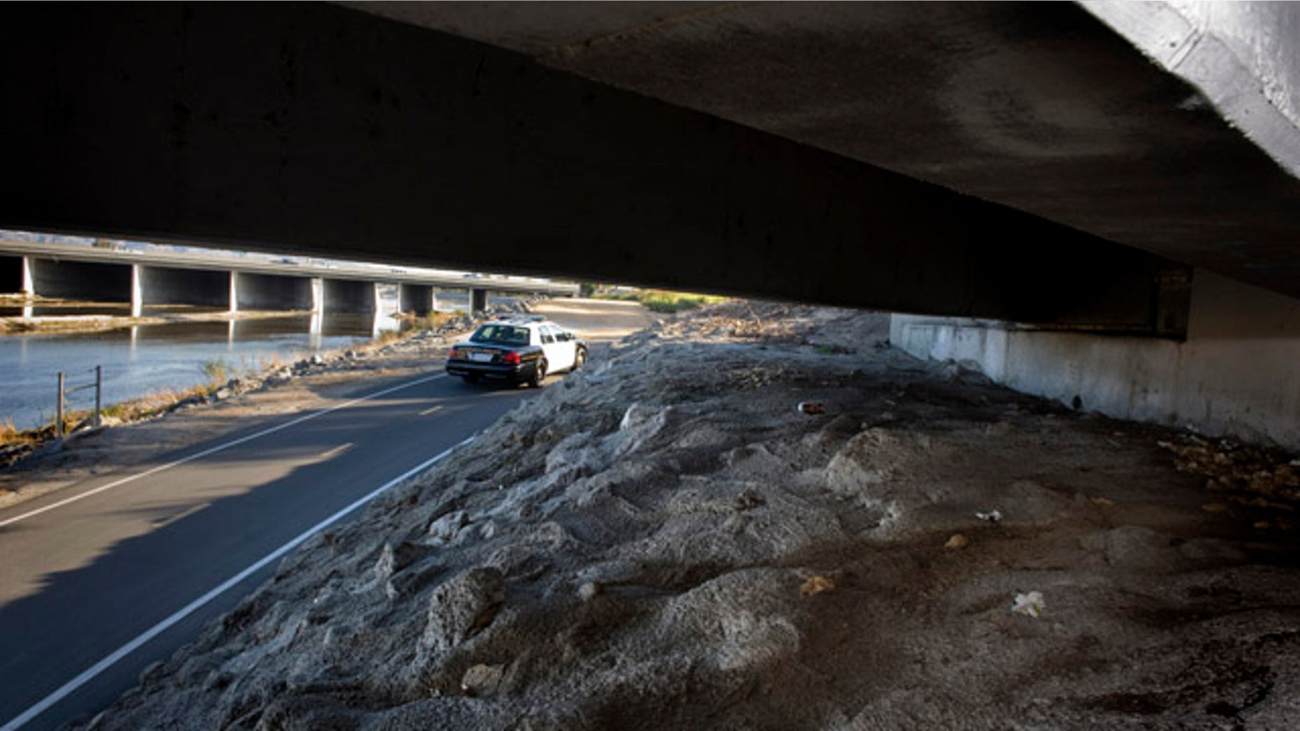Jan. 3, 2012: A number of personal belongings lay under the Tustin Avenue bridge on the Santa Ana River Trail in Anaheim, Calif., just a few 100 yards to the west of the fatal stabbing of transient Lloyd Middaugh, 42. Anaheim Police Chief John Welter told a news conference Wednesday, Jan. 4, 2012 that last month's slayings of three homeless men were likely the work of a serial killer. Authorities believe one person is responsible for the stabbing deaths, which occurred between Dec. 20 and Dec. 30, Welter said. In each case, a middle-aged man was targeted.