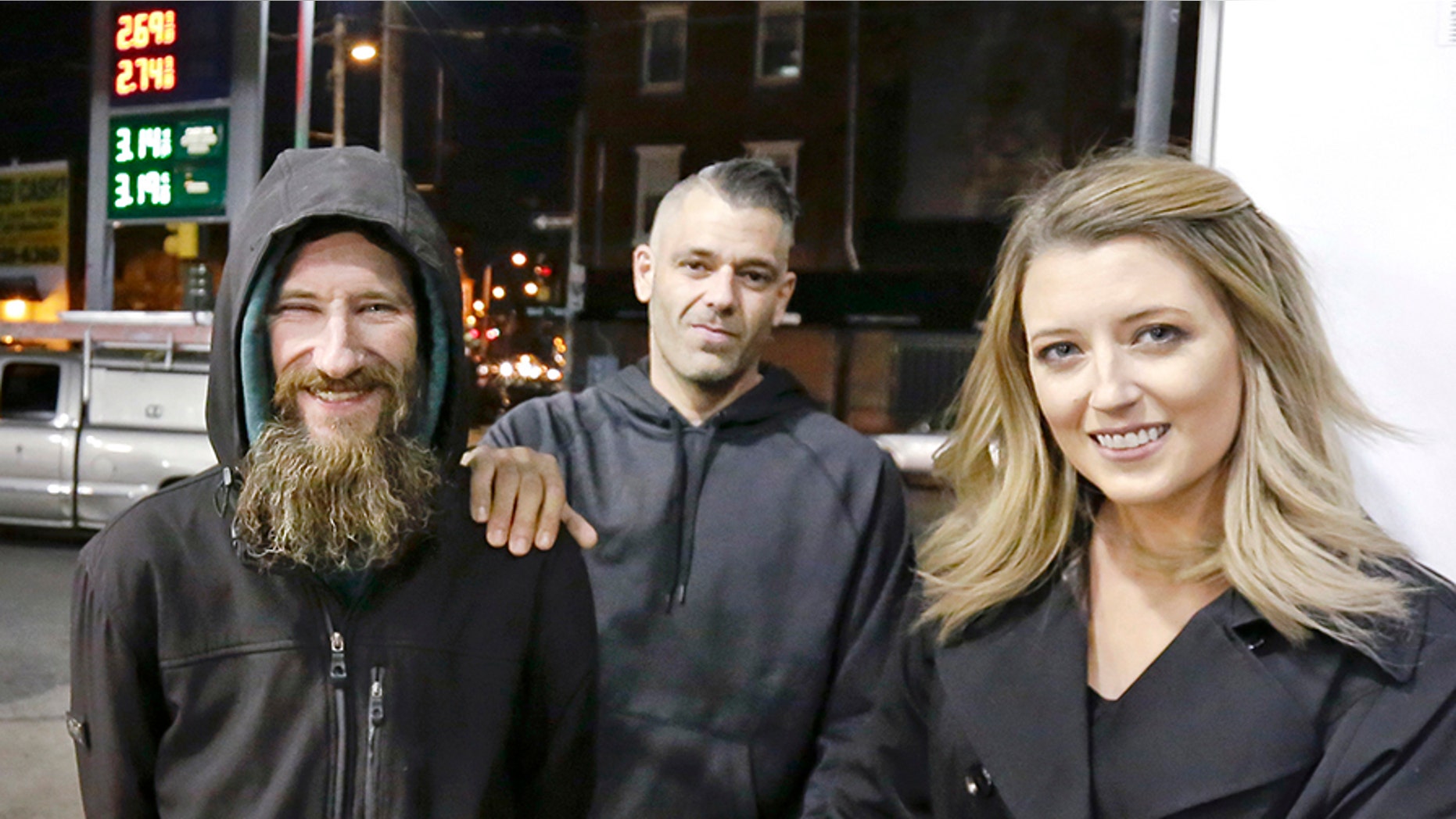 When Kate McClure, right, ran out of gas, Johnny Bobbitt Jr., left, who is homeless, gave his last $20 to buy gas for her. McClure, seen with boyfriend Mark D'Amico, middle, started a Gofundme.com campaign for Bobbitt that has raised more than $13,000. (Elizabeth Robertson/The Philadelphia Inquirer via AP)