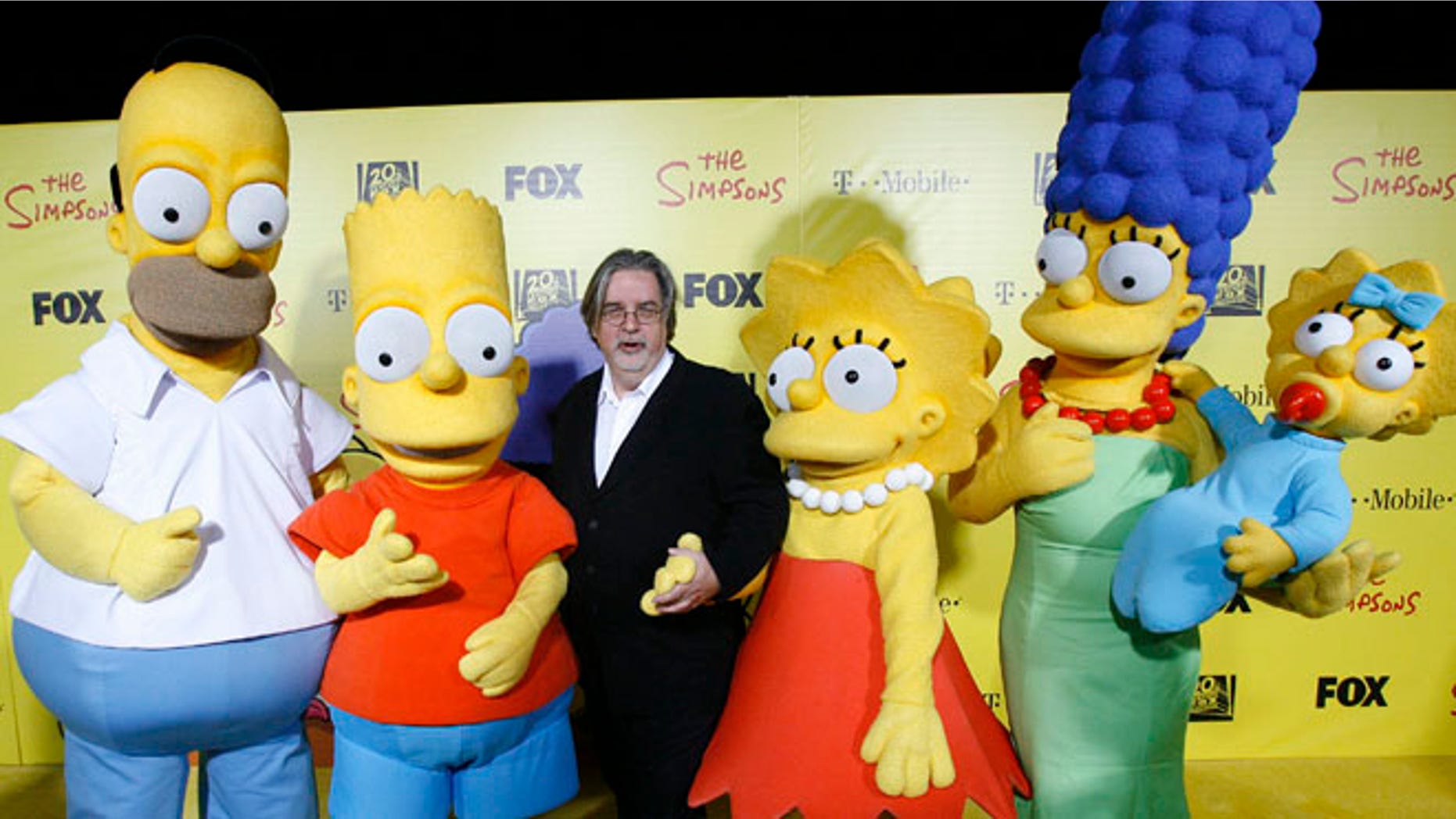 Oct. 18, 2009: Matt Groening (C), creator of The Simpsons, poses with characters from the show (L-R) Homer, Bart, Lisa, Marge and Maggie at the 20th anniversary party for the television series at Barker hangar in Santa Monica, California. (Reuters)