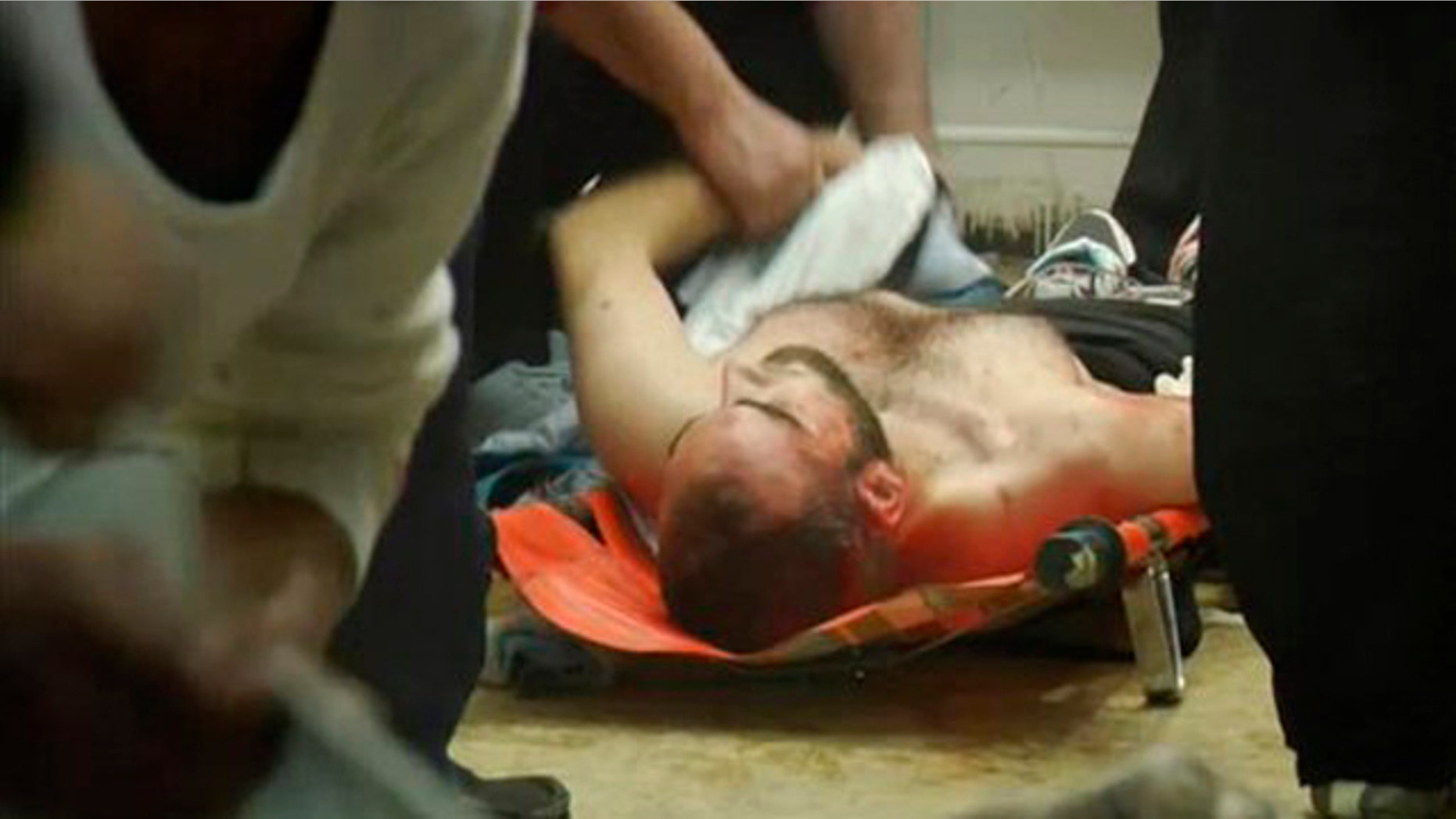 This image taken from video filmed over the past several days by an independent cameraman and made available Feb. 7, 2012, shows medical staff trying to help the injured at a hospital in Homs, Syria.