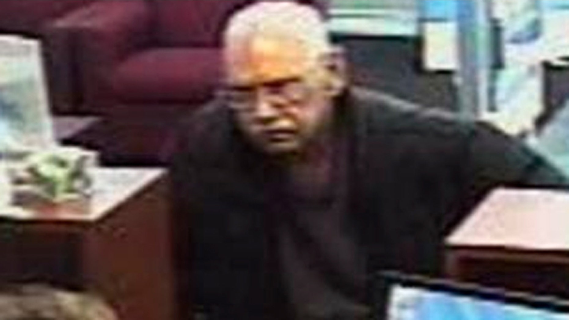FILE: Surveillance photo provided by the FBI shows 73-year-old Walter Unbehaun, an ex-convict from Rock Hill., S.C., during a bank robbery in Niles, Ill. Unbehaun allegedly told investigators he intended to get caught so he could live his final years behind bars.