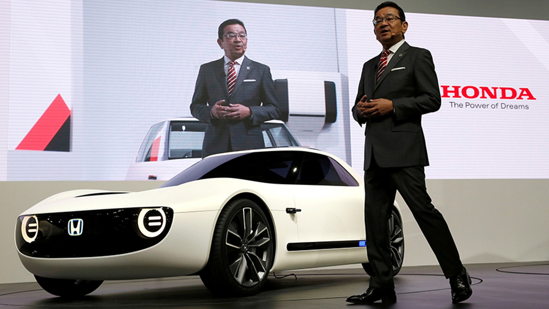 Honda CEO Takahiro Hachigo unveiling the Sports EV at the Tokyo Motor Show