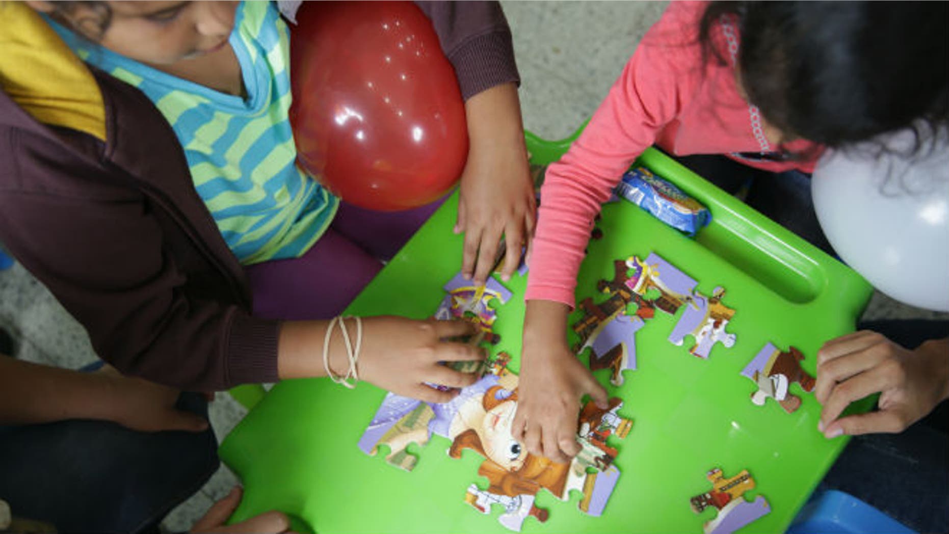 Children deported from the U.S. play after arriving at Ramon Villeda international airport in San Pedro Sula, in this July 14, 2014 handout provided by the Honduran Presidential House. REUTERS/Presidential House/Handout via Reuters