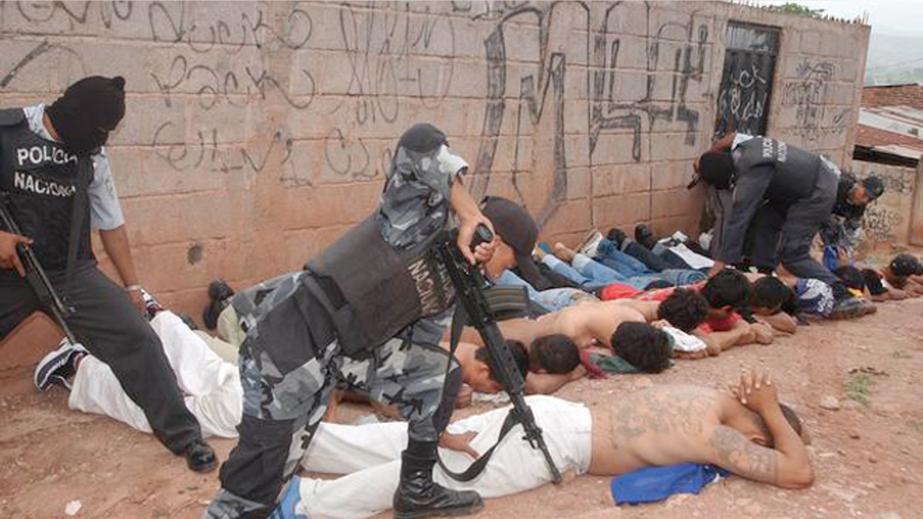 Police officers detain members of the Mara 18 and MS 13 gangs in Honduras.