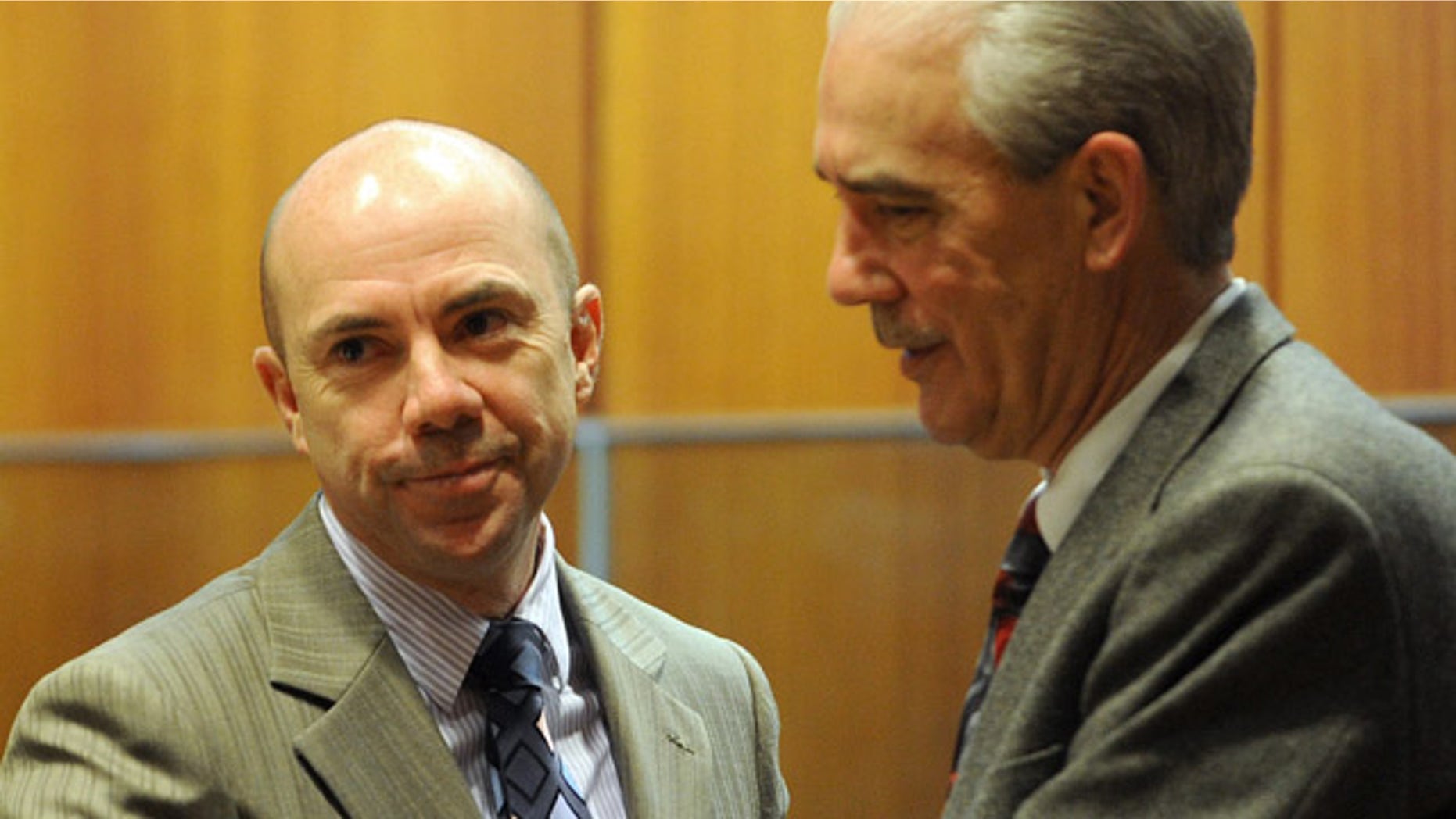 Feb. 21: Tina Watson's father, Tommy Thomas, right, greets dive master Wade Singleton after Singleton testified in the murder trial of Gabe Watson.