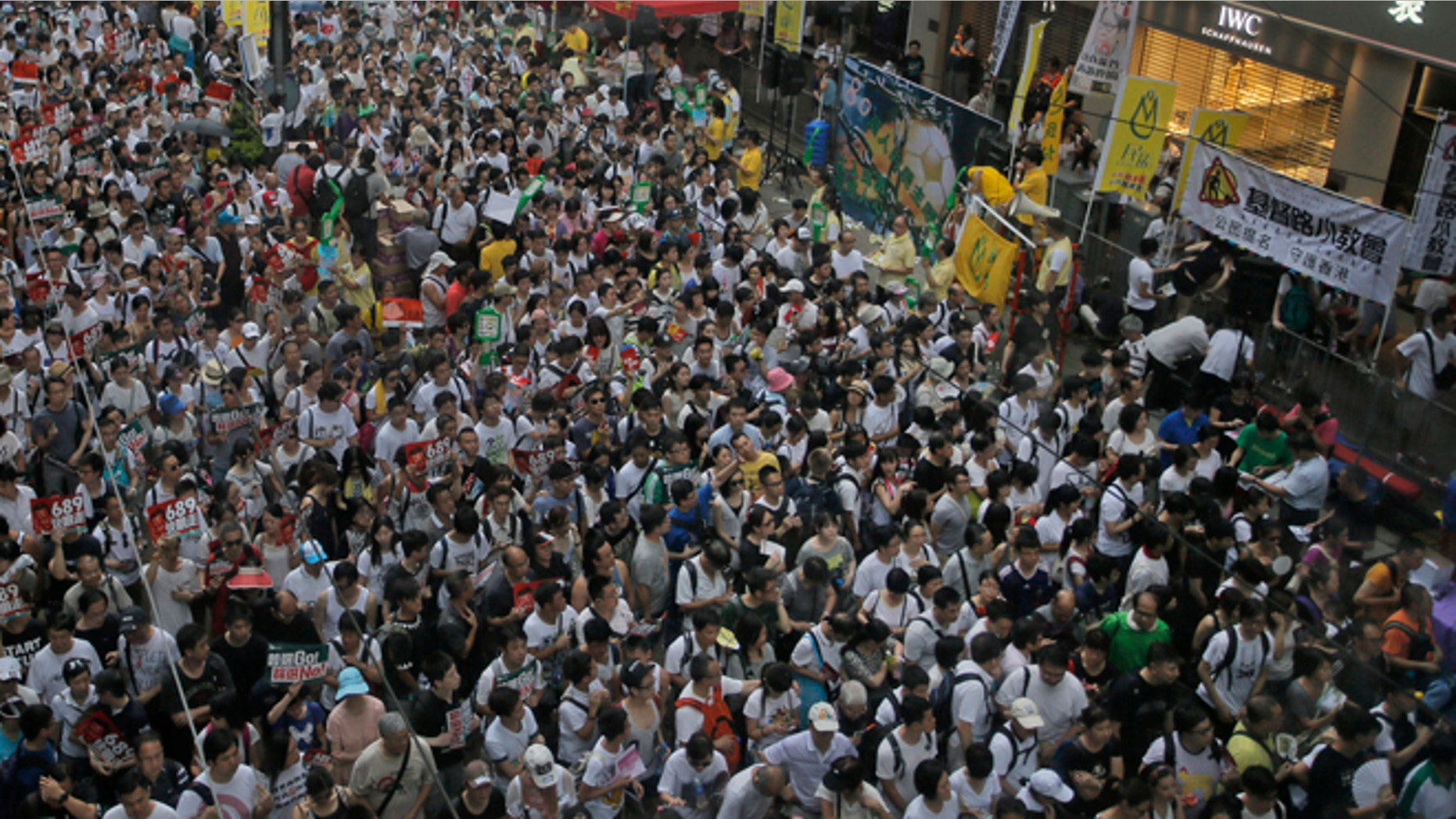 July 1, 2014: Tens of thousands of people fill in a street during a march at an annual protest in downtown Hong Kong. Hong Kong residents marched through the streets of the former British colony to push for greater democracy in a rally fueled by anger over Beijing's recent warning that it holds the ultimate authority over the southern Chinese financial center.