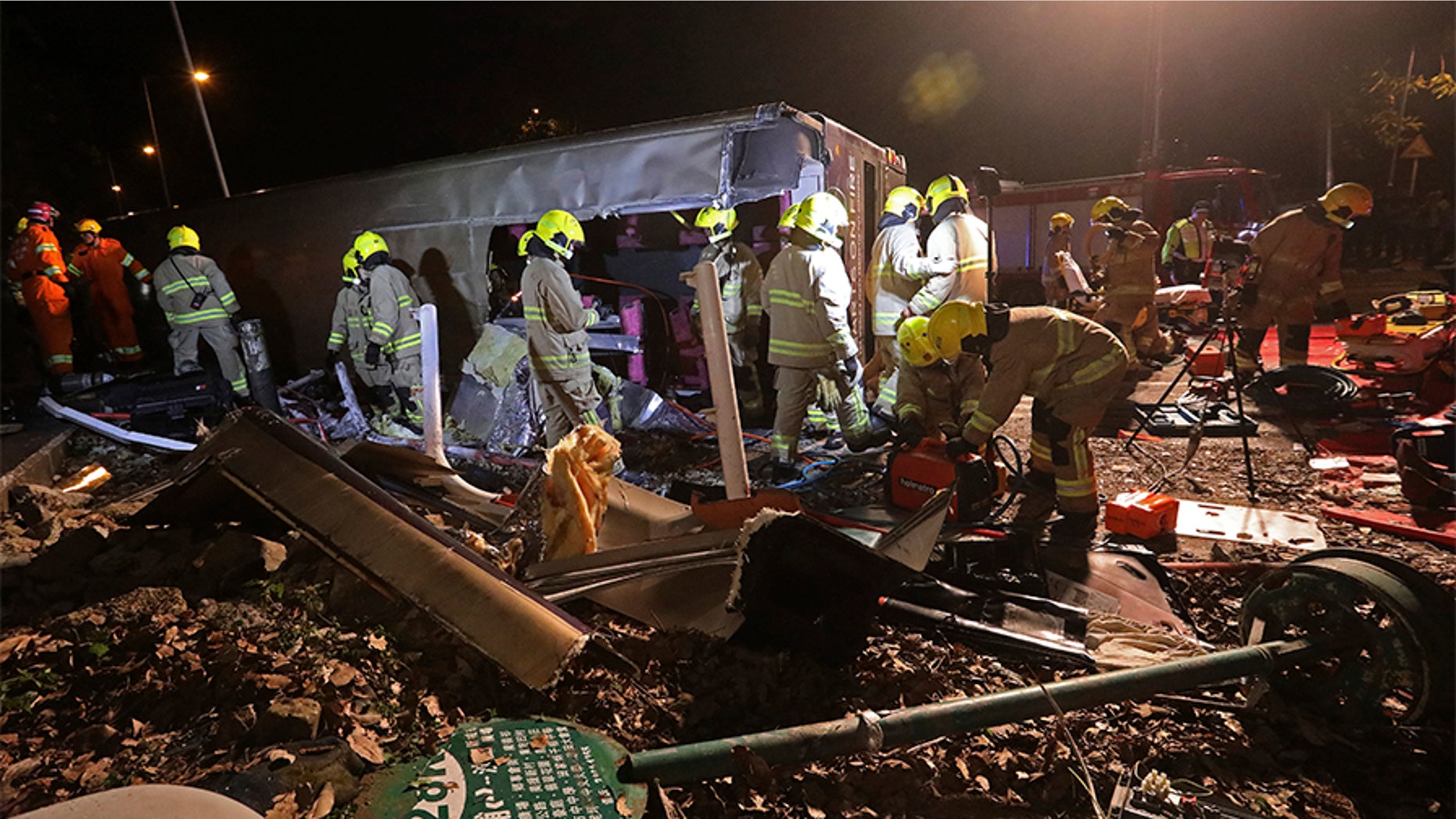 Firemen work at the scene of a bus crash in Hong Kong, Saturday, that killed 18 people.