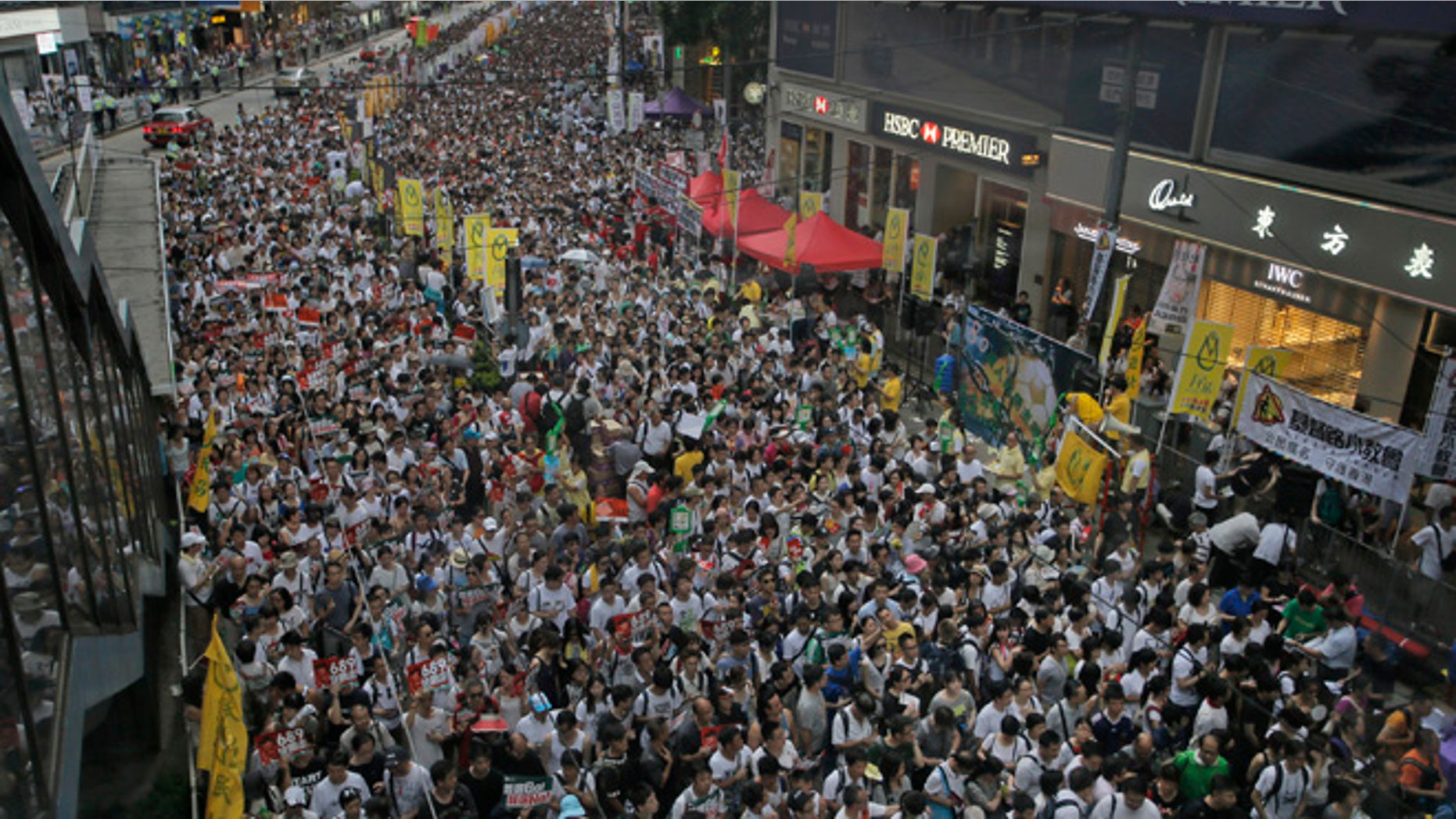 July 1, 2014: Tens of thousands of people fill in a street during a march at an annual protest in downtown Hong Kong.