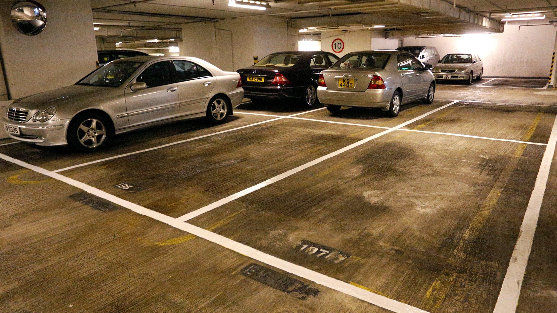 Cars are parked near empty spots at a residential building in Hong Kong Tuesday, Nov. 27, 2012.