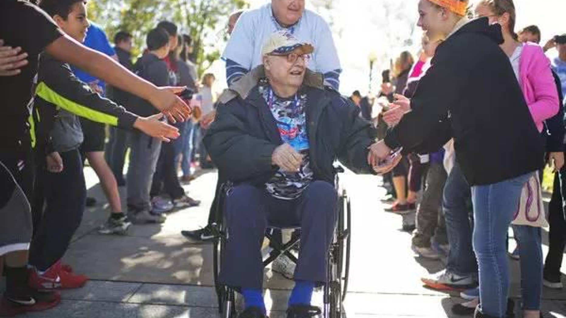 Anthony Petruzzi, 92, a veteran of World War II, Korea, and Vietnam is greeted as he arrives with an Honor Fight group from Kansas City, Mo., at the WWII Memorial on Veteran's Day, November 11.