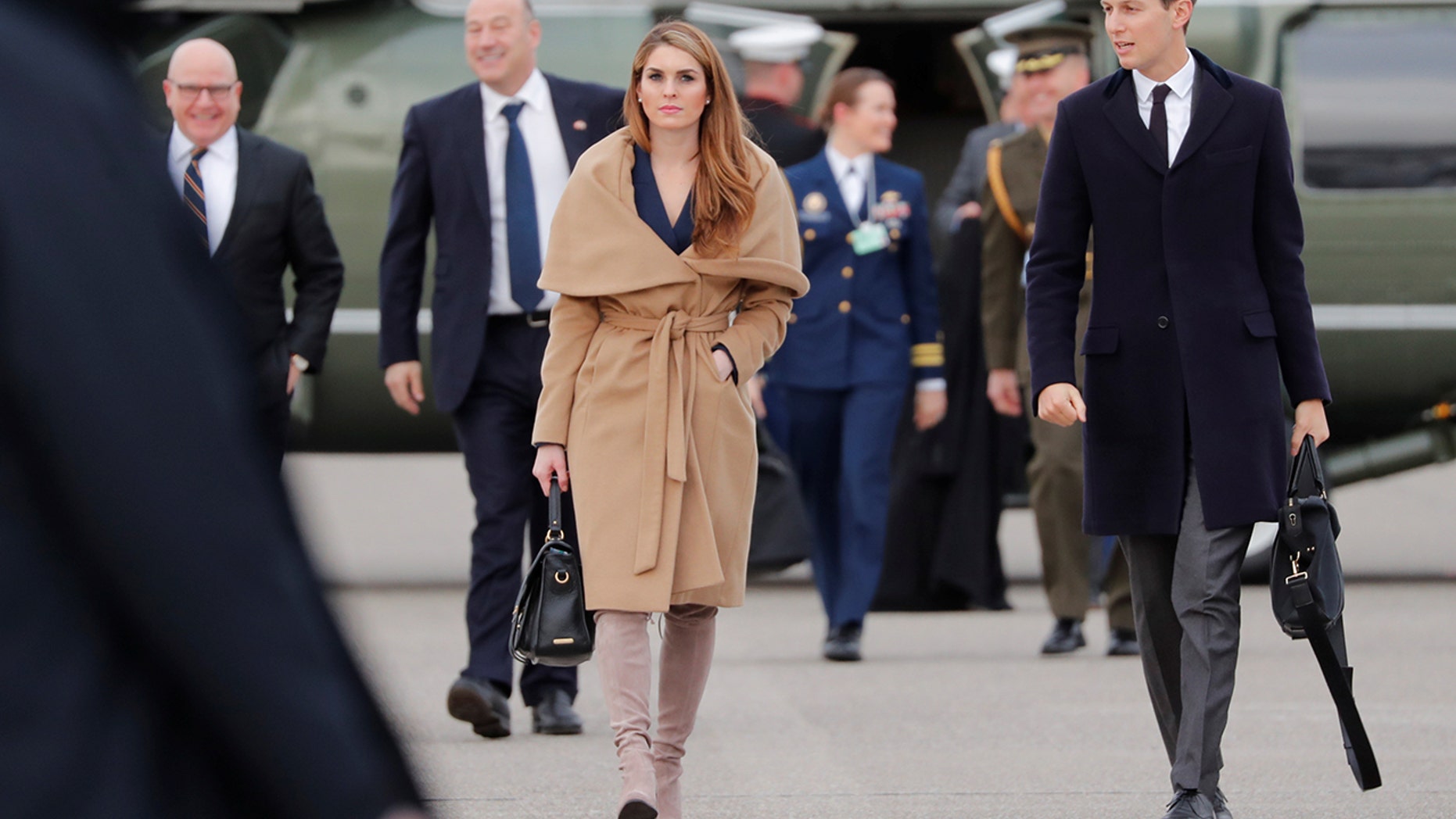 The White House communications director stunned in a pair of taupe suede, thigh-high Stuart Weitzman boots, priced at $798, and a navy blue wrap dress.