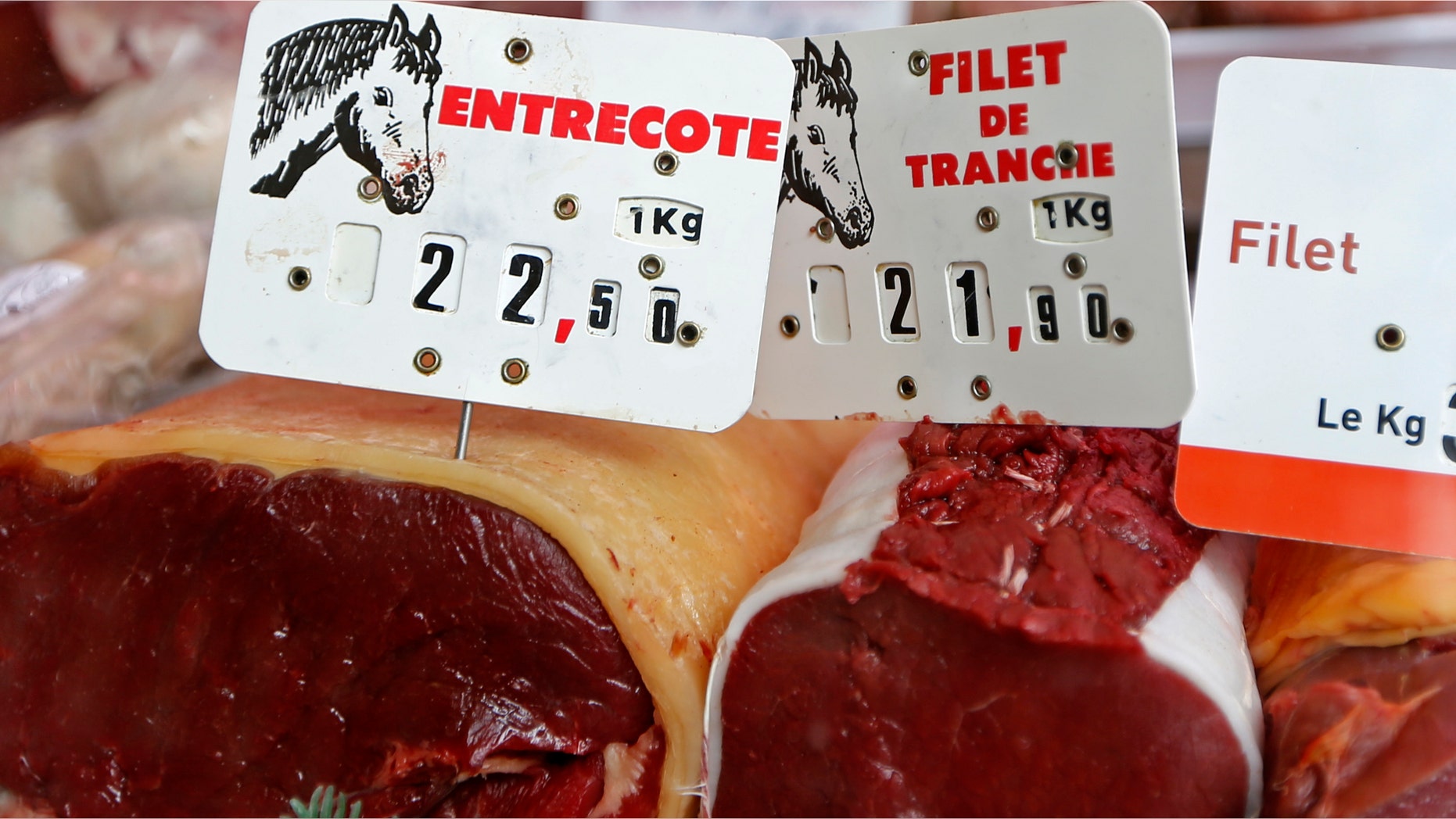 Cuts of horsemeat are displayed in a shop window at the horse butchery near Paris.