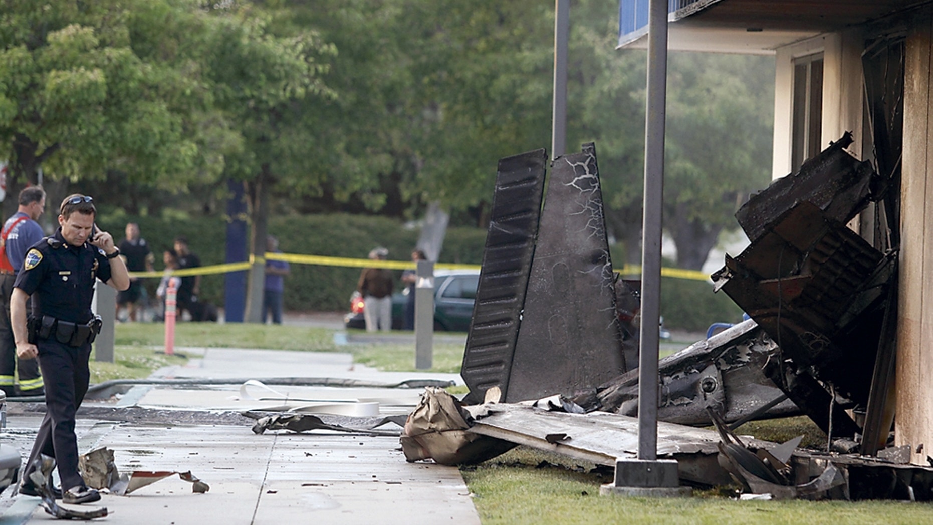 July 7: The wreckage of a small plane sticks out of the side of an unoccupied office building at Watsonville Community Hospital in Watsonville, Calif. The plane had just taken off from the Watsonville Municipal Airport. Two people were killed in the crash.