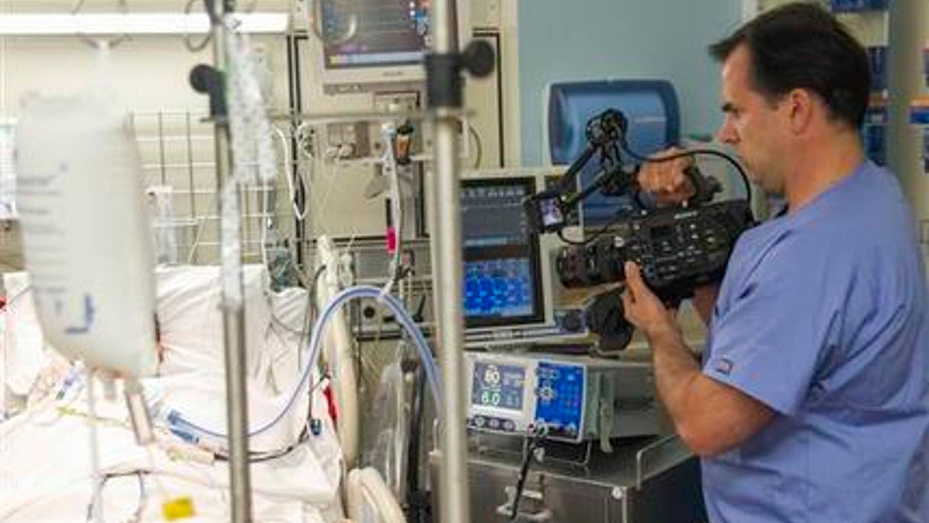 Feb. 23, 2015: In this photo, Dr. Angelo Volandes films a patient at Straub Clinic and Hospital in Honolulu, for videos he develops that educate families about end-of-life care options, such as CPR.