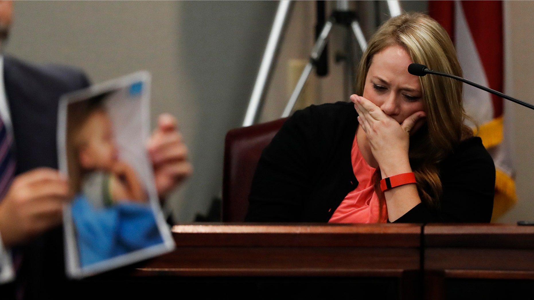 Leanna Taylor cries as an attorney shows photographs of her son Cooper to the jury during a murder trial for her ex-husband Justin Ross Harris Monday, Oct. 31, 2016, in Brunswick, Ga.
