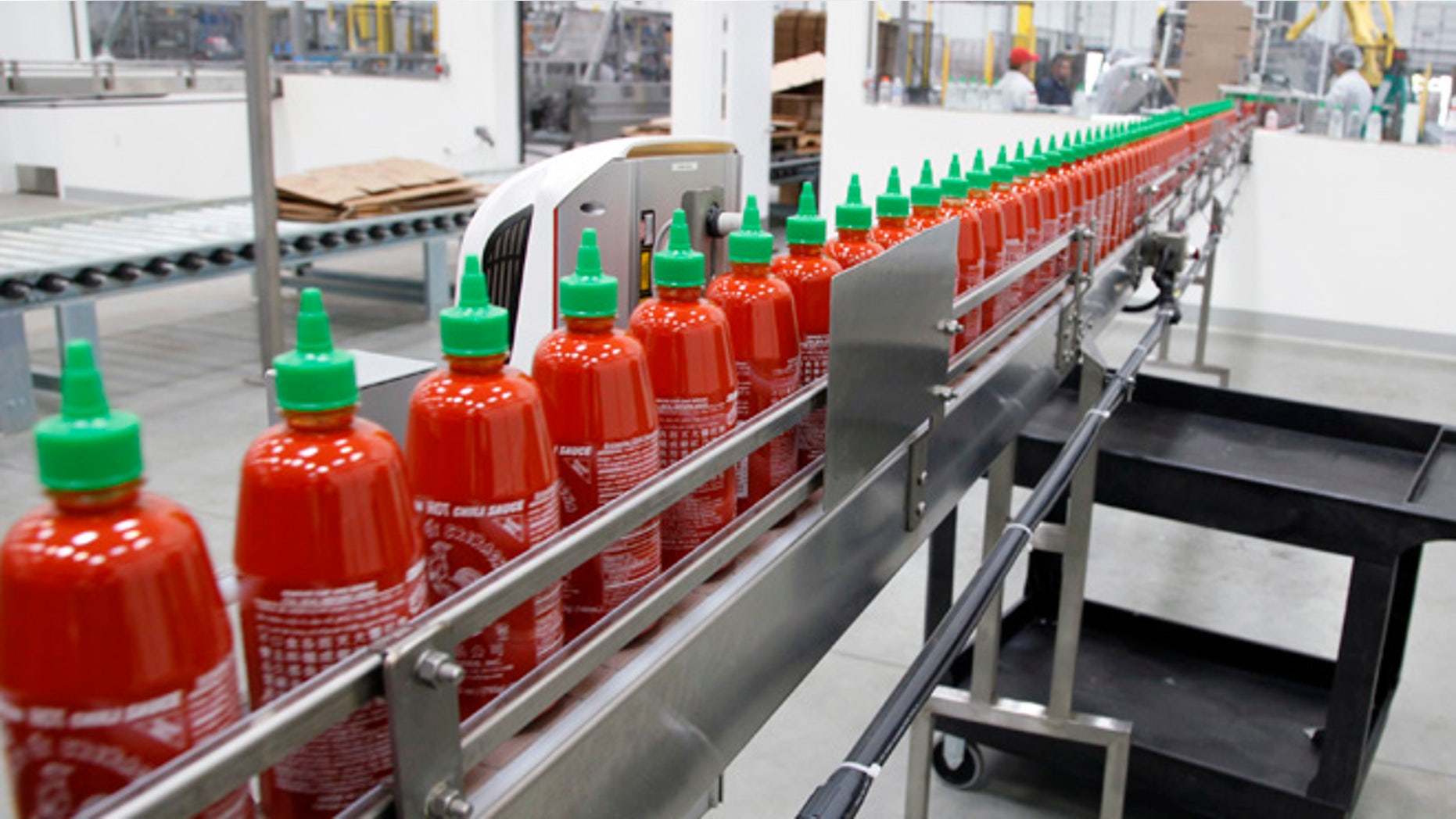 Oct. 29, 2013: This photo shows Sriracha chili sauce moves along a production line during at the Huy Fong Foods factory in Irwindale, Calif.