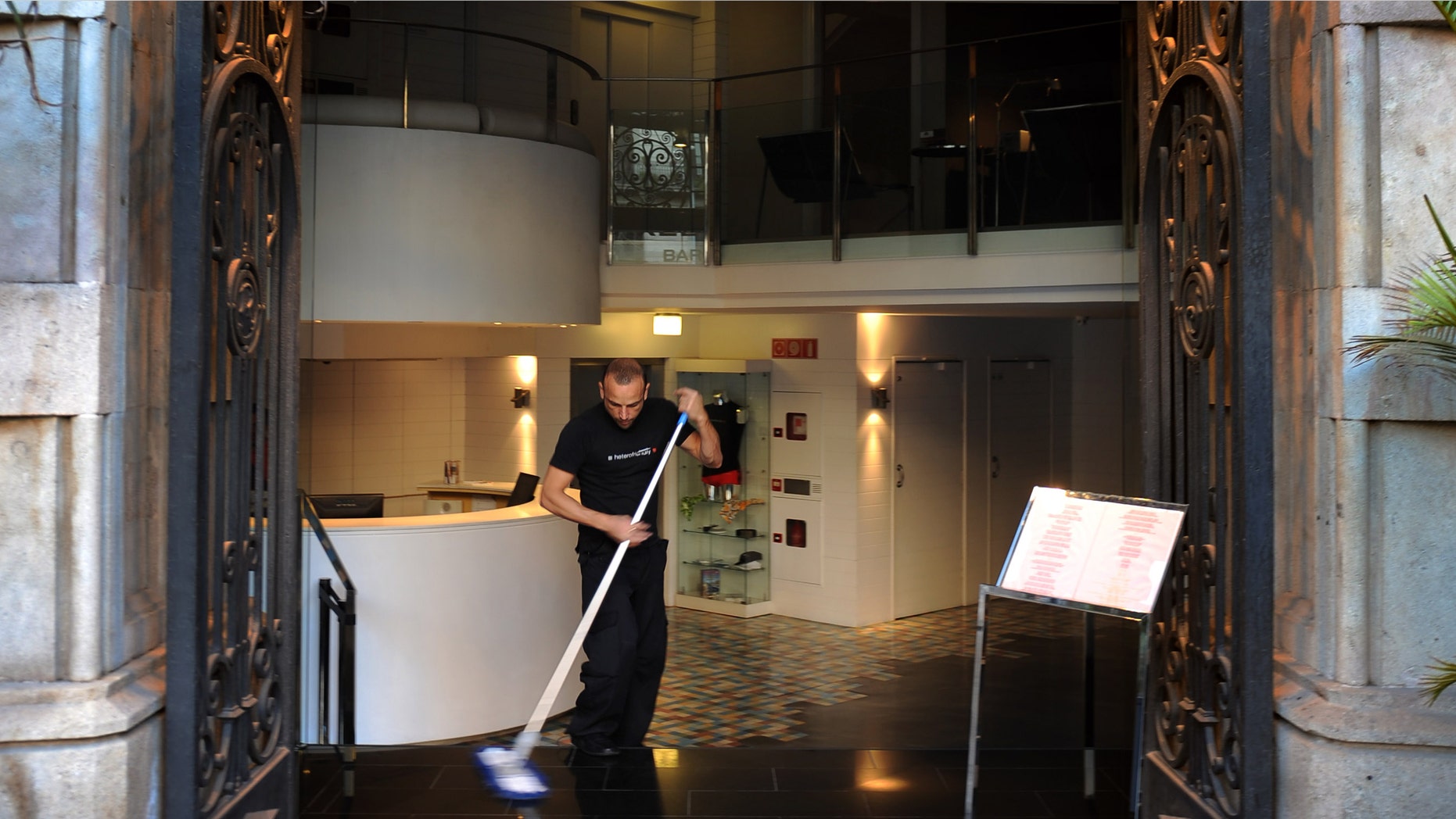 BARCELONA, SPAIN - MARCH 17: A worker cleans the entrance of the Axel Hotel on March 17, 2009 in Barcelona, Spain. Axel Hotel is the first international hotel chain to cater specifically to homosexuals. Axel Hotels has also opened hotels in Berlin and Buenos Aires. (Photo by Jasper Juinen/Getty Images)