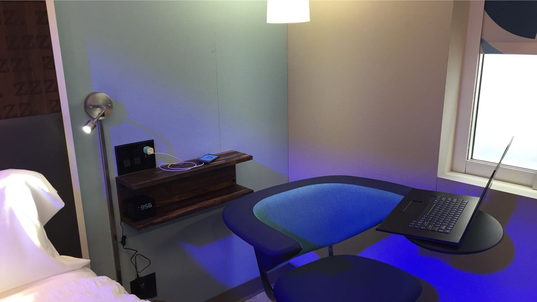 A prototype room of Hilton’s new Tru brand on display in Los Angeles. Instead of desks, rooms in the new hotels will feature chairs with large armrests to place a laptop.