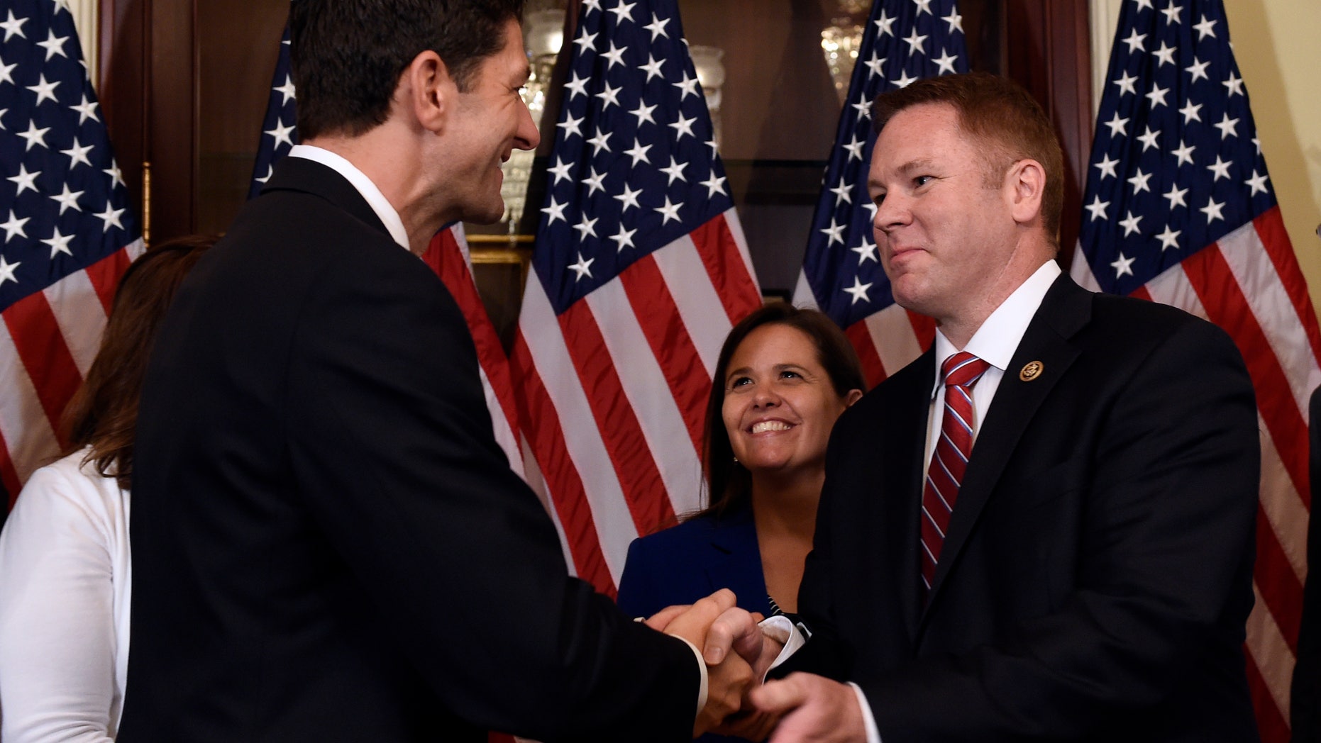 June 9, 2016: House Speaker Paul Ryan of Wis., left, shakes hands with Rep.-elect Warren Davidson, R-Ohio, right, before Davidson is officially sworn in on Capitol Hill in Washington.