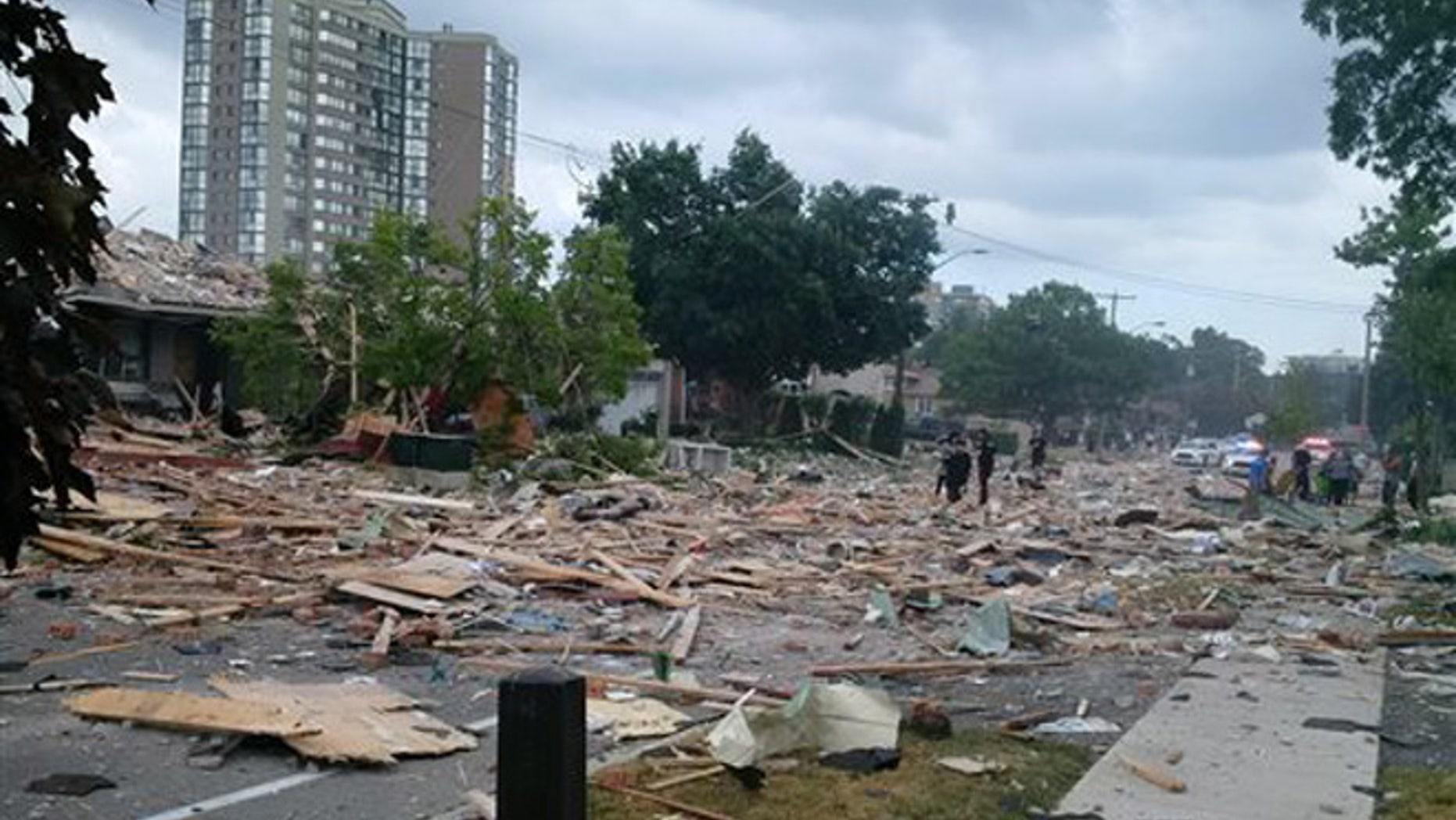Debris litters a street after a house explosion in Mississauga, Ontario, Tuesday, June 28, 2016.