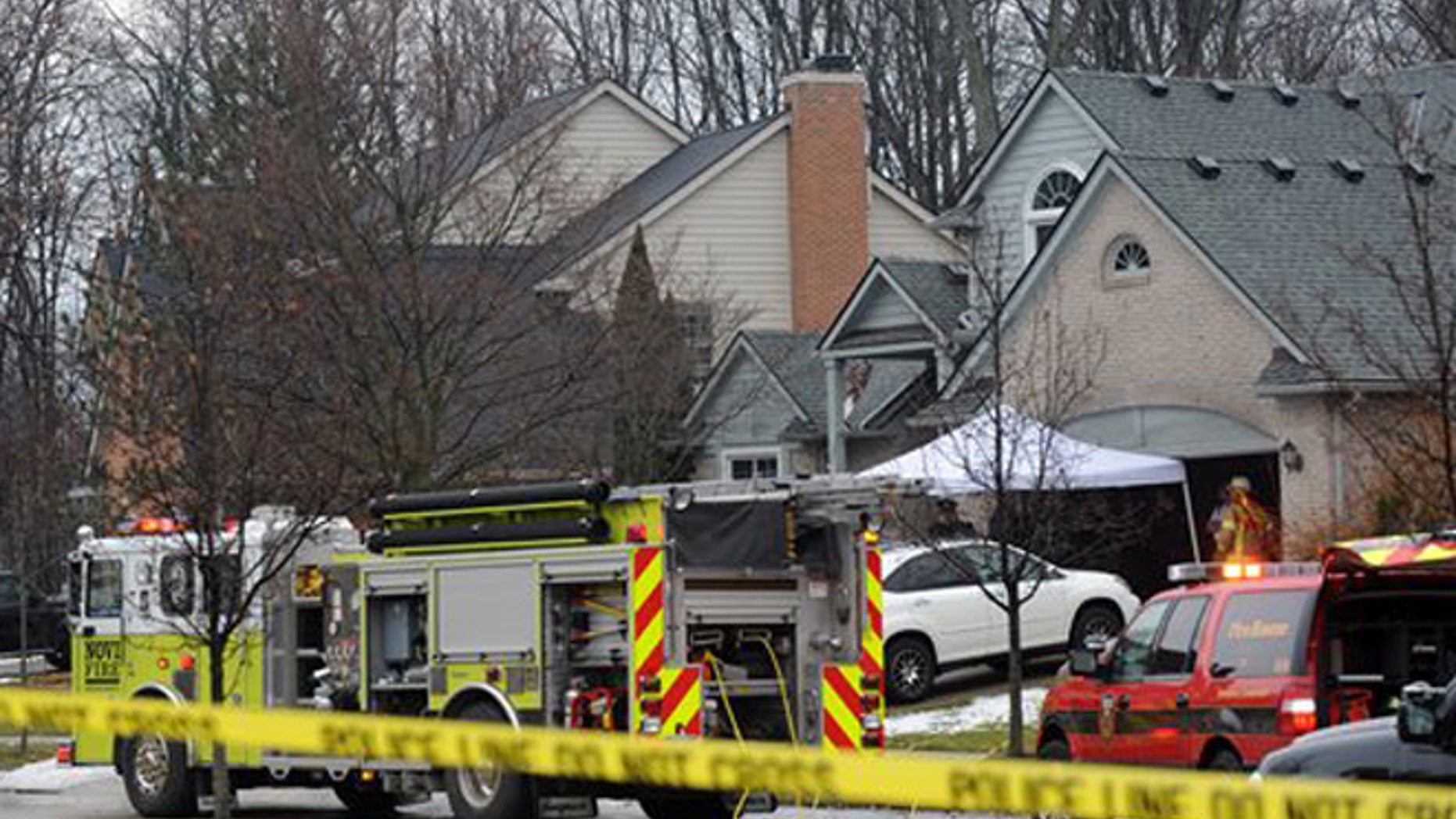 Police and fire officials investigate a house fire that killed five people at a home in Novi, Mich., Sunday, Jan. 31, 2016.