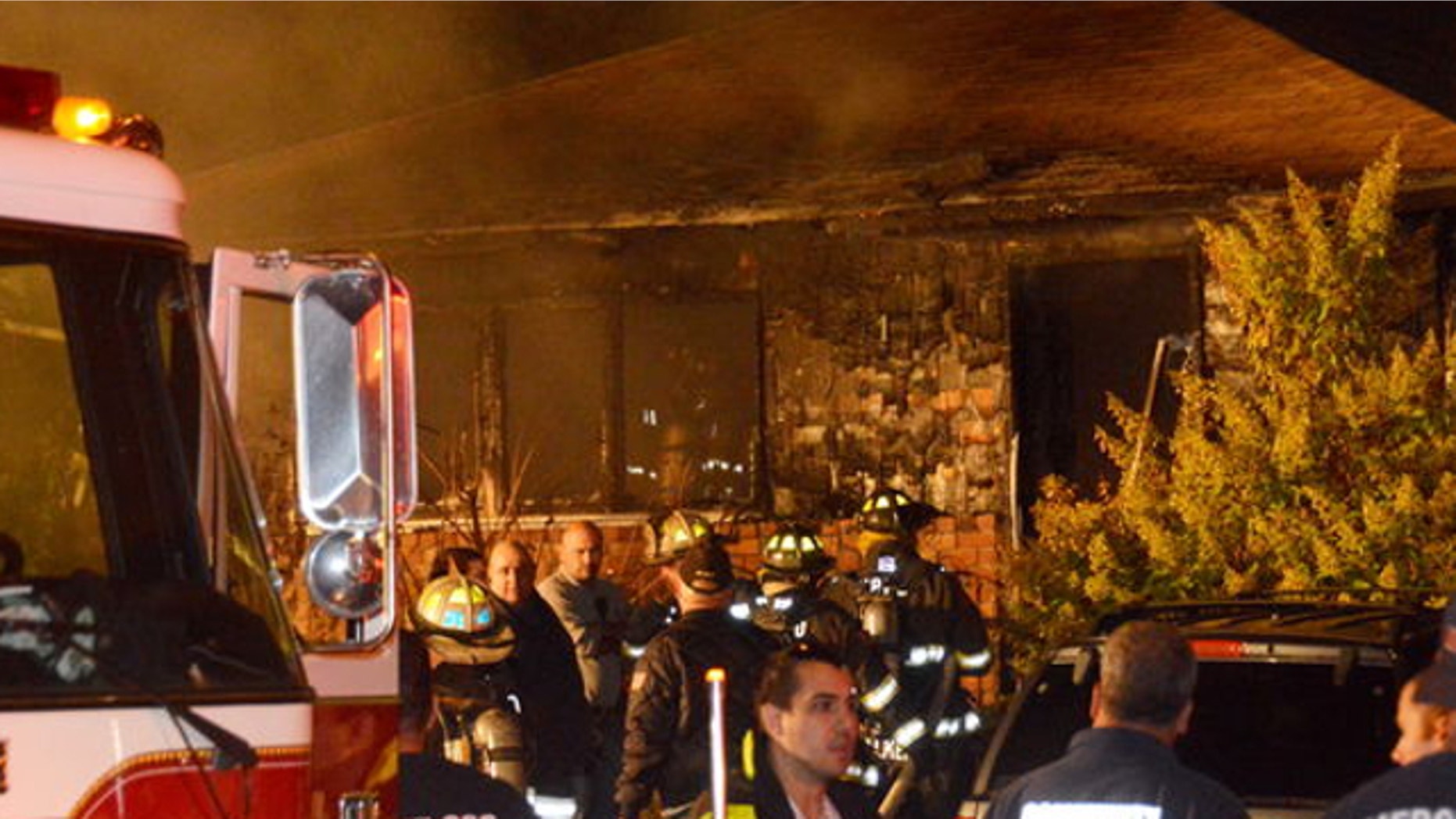 Oct. 11, 2013: Members of the Mastic Beach Fire Department look for victims after bringing a fire under control in a large house in Shirley, N.Y. Frid