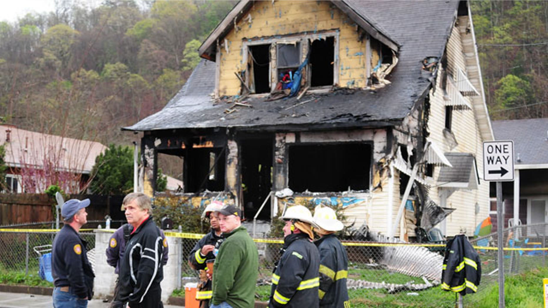 Mar. 24, 2012: Mayor Danny Jones and Charleston, WVa., firefighters look over the scene of a house fire.
