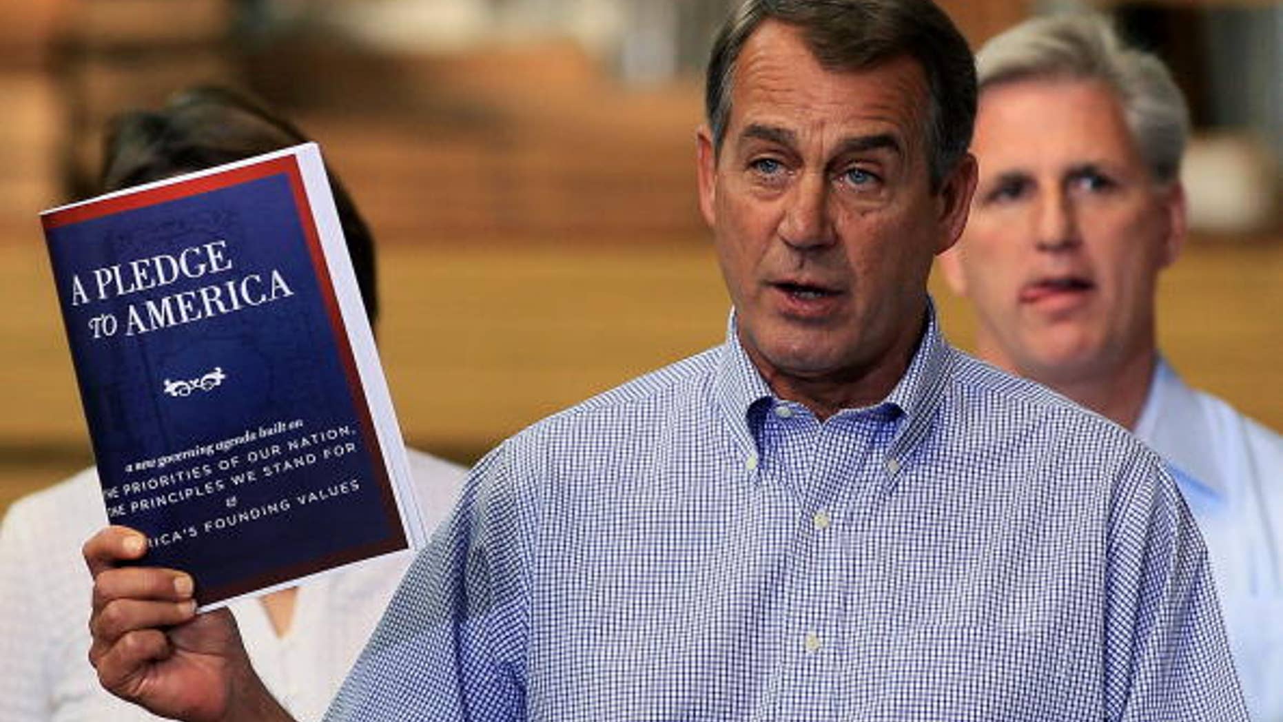 STERLING, VA - SEPTEMBER 23: House Minority Leader John Boehner (R-OH), holds a copy of "A Pledge To America" plan while flanked by members of Congress and small business owners during an event at the Tart Lumber on September 23, 2010 in Sterling, Virginia. House Republicans held their "Pledge To America" news conference at the family owned lumber store to unveil their proposed governing agenda for the upcoming 111th Congress. (Photo by Mark Wilson/Getty Images)