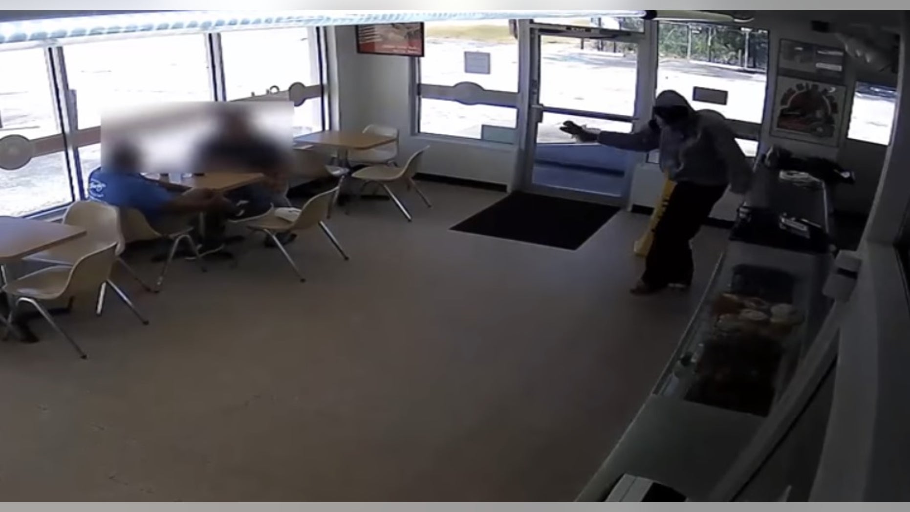 The robbery suspect hand-delivered crullers to a couple of customers.