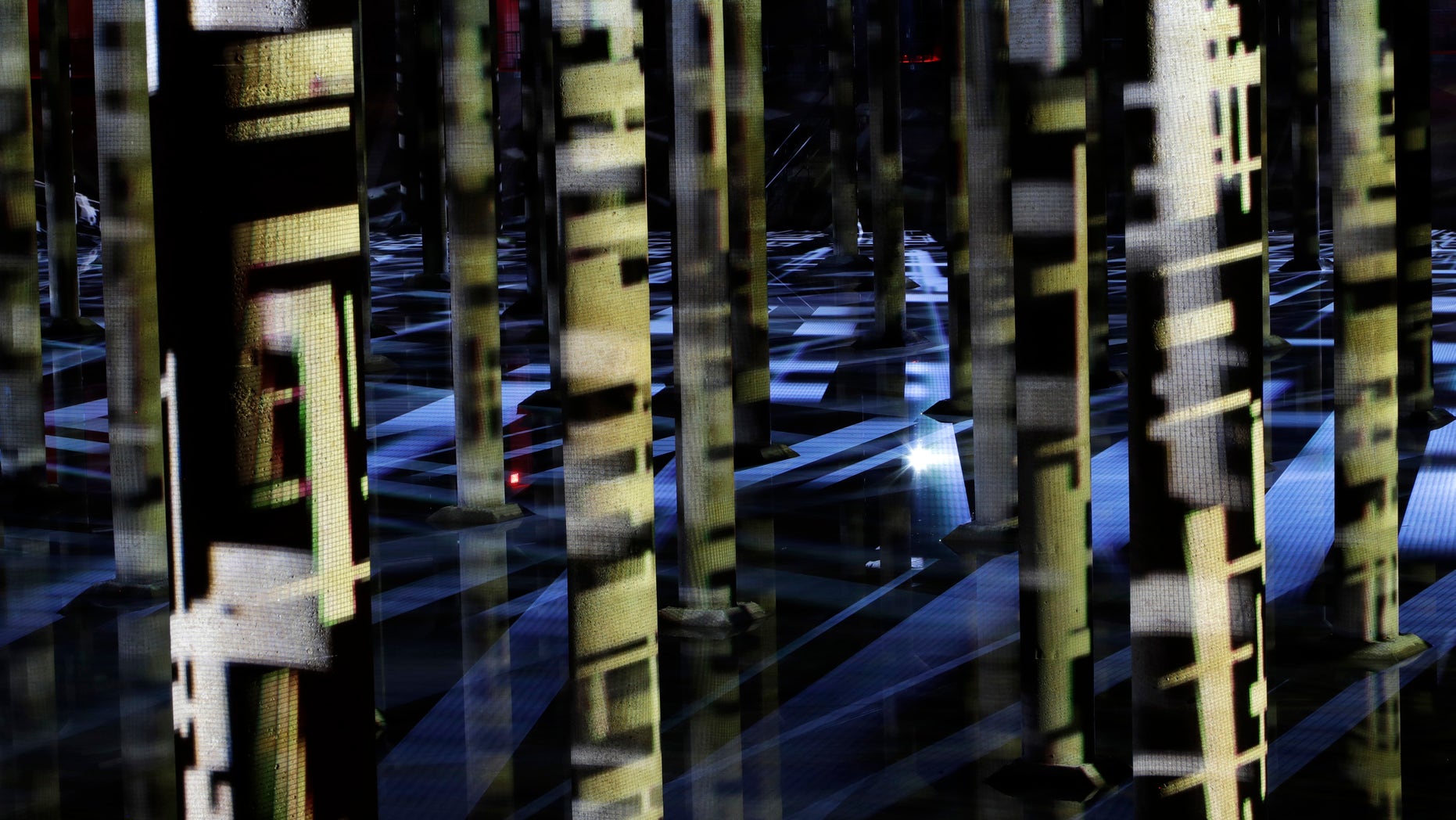 In this Friday, Dec. 16, 2016, photo, the exhibition of an abstract-video installation called "Rain" by Venezuelan artist Magdalena Fernández is projected inside a former water reservoir dubbed the "Cistern" in Houston. Once eyed for demolition, the former water reservoir built in 1926 has now found new life as a public space that's also serving as an unusual canvas for art. The reservoir's rebirth is the latest example of efforts by cities around the country to reuse and repurpose abandoned and dilapidated pieces of infrastructure as public spaces. (AP Photo/David J. Phillip)
