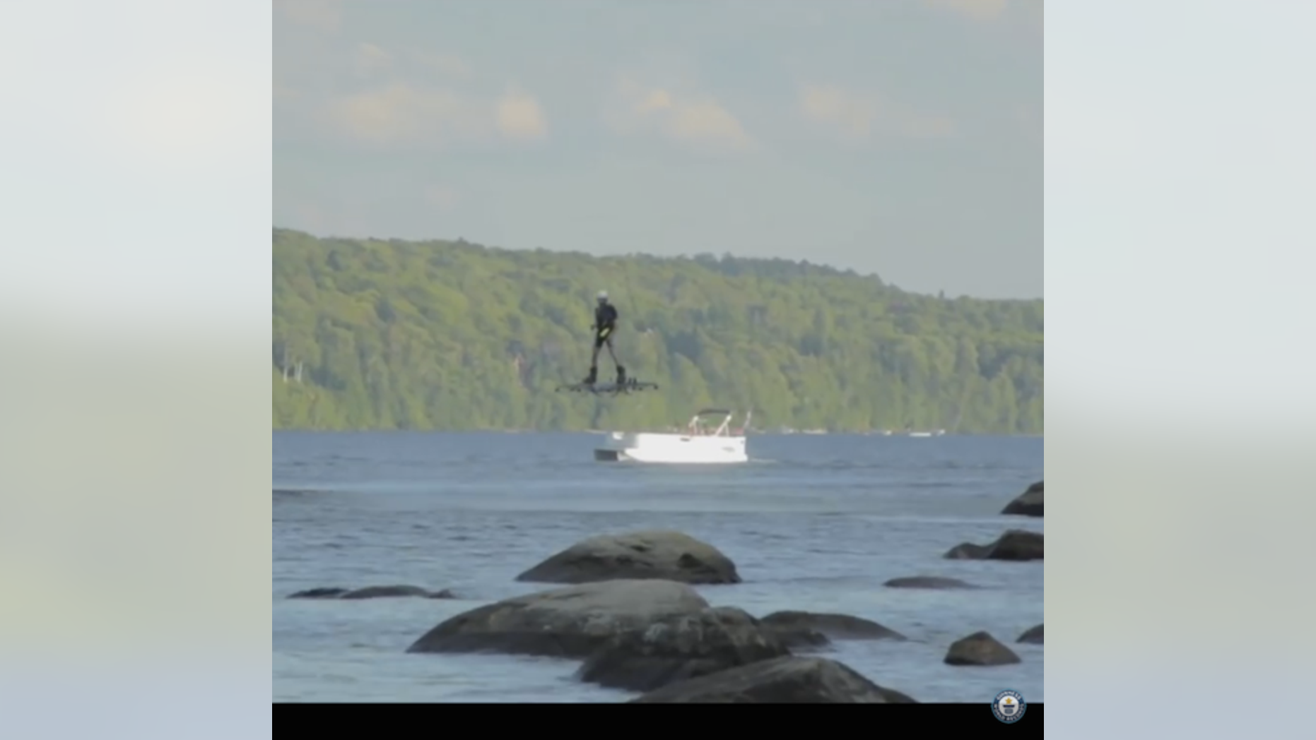 Catalin Alexandru Duru soars over a lake in Quebec, Canada in this screenshot of the Guinness World Records YouTube video.