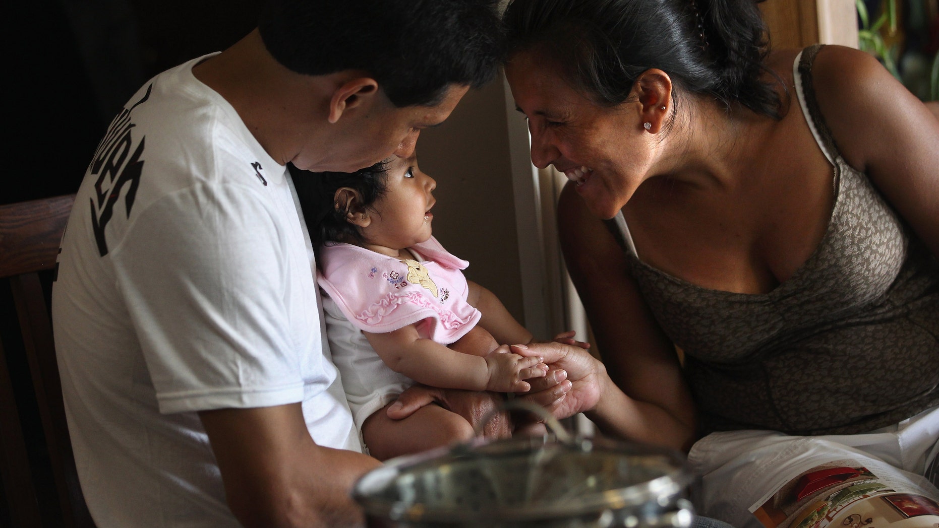 DENVER, CO - JULY 10: Undocumented Mexican immigrant Jeanette Vizguerra sits with her husband Salvador and daughter Zuri, 5 months, on July 10, 2011 in Denver, Colorado. Vizguerra, a mother of four children, three of whom were born in the U.S. as American citizens, is facing a deportation hearing July 13 at Denver's Federal Courthouse. If Vizguerra is deported back to Mexico, she says her husband and children will stay on in the United States. Just one of millions of undocumented immigrants living in the U.S., Vizguerra first came to Colorado from Mexico City with her husband and first child 14 years before. Now an activist for the immigration advocate group Rights For All People, she also owns a janitorial service and says she has always paid state and federal taxes on her income. Some two years ago she was stopped by a traffic policemen for driving with expired tags and taken to jail when she could not prove her legal immigration status. Out on bail during court proceedings, she now faces the real possibility that she will be deported to Mexico and separated from her family in the United States. (Photo by John Moore/Getty Images)