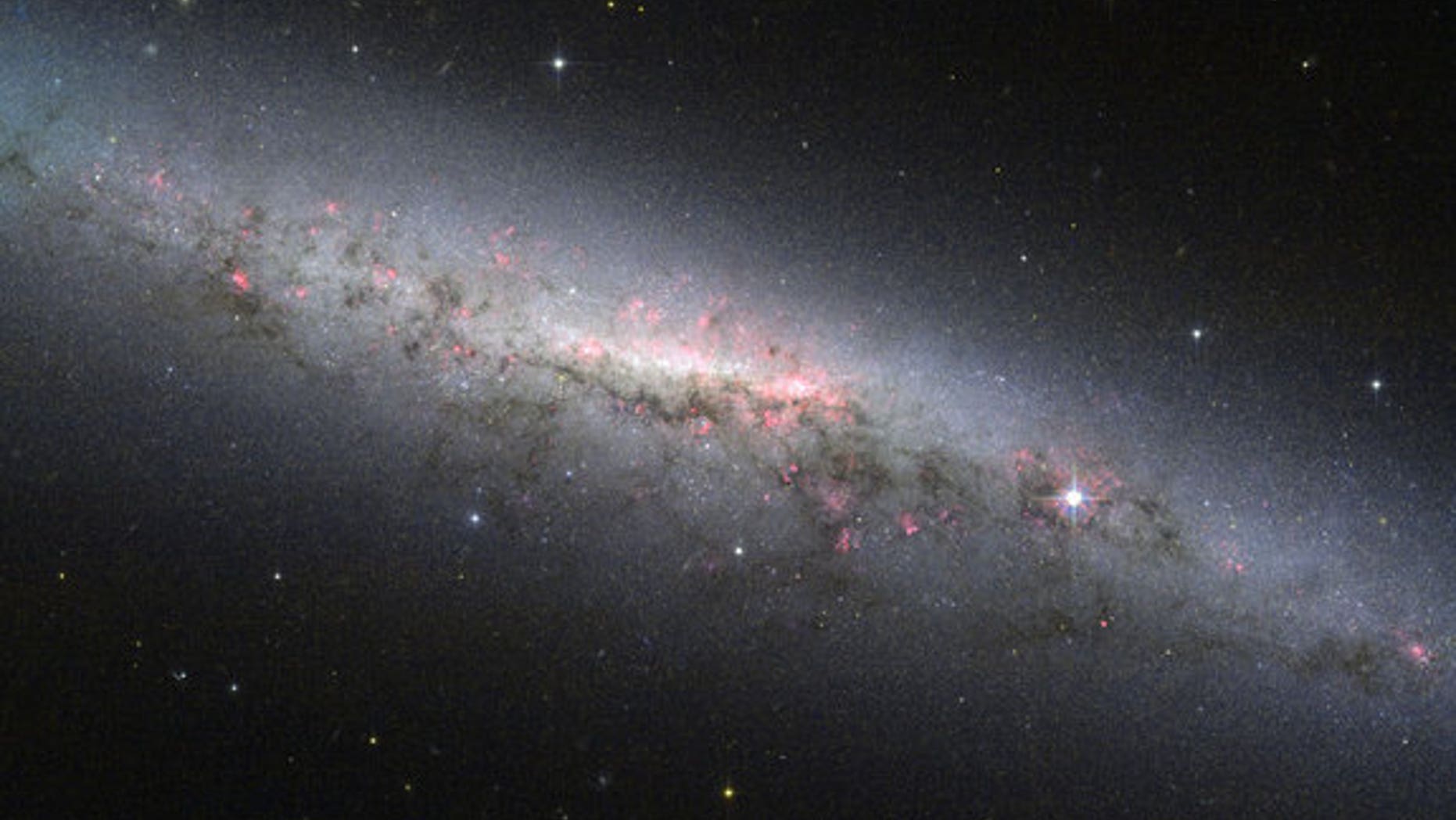 This shot from the Hubble Space Telescope shows an edge-on view of the star-forming galaxy NGC 7090, which is located about 30 million light-years from Earth.