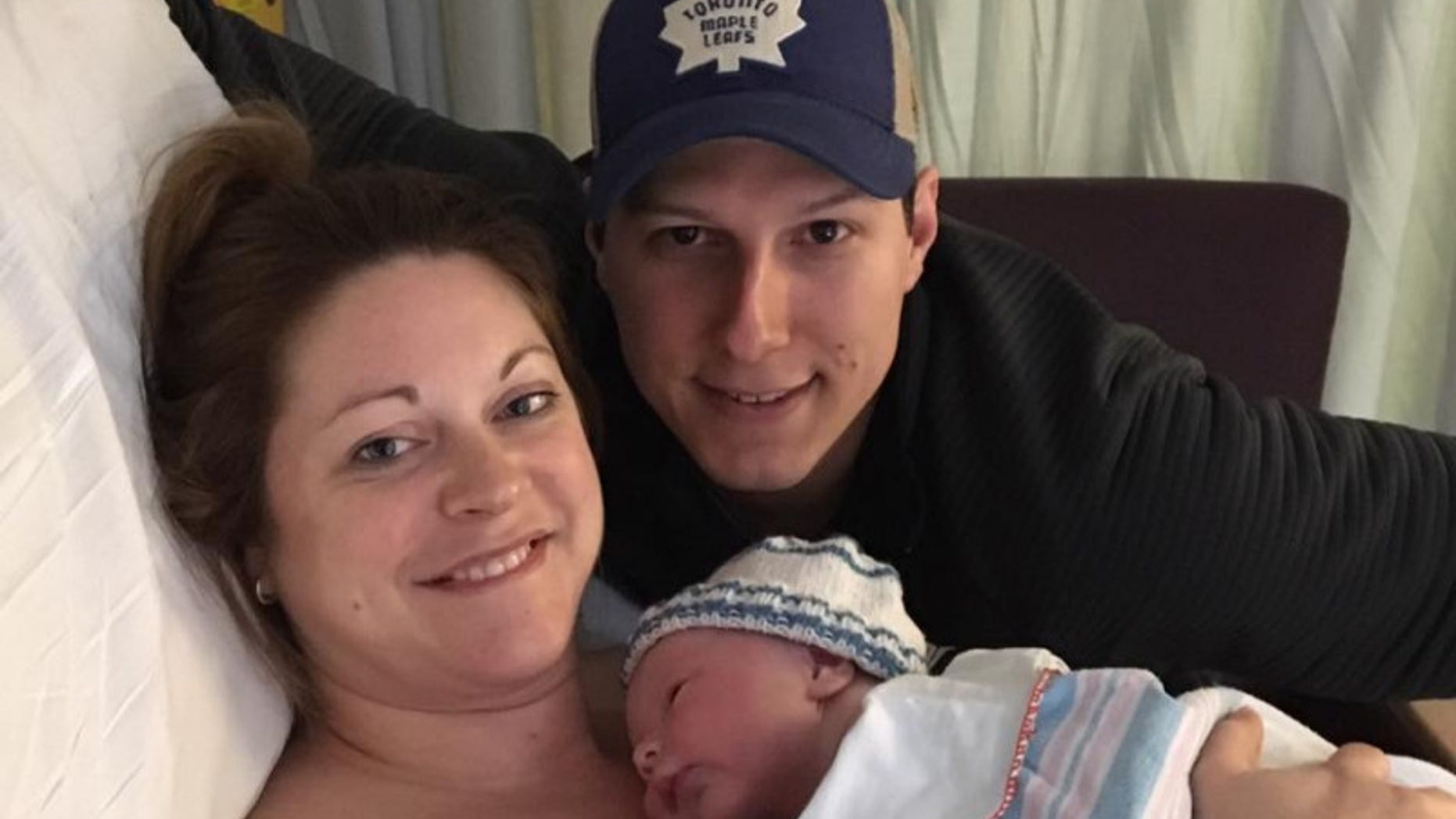 Lindsey Hubley is pictured with her newborn son and fiance. Days after this photo she was diagnosed with a flesh-eating bacteria infection.
