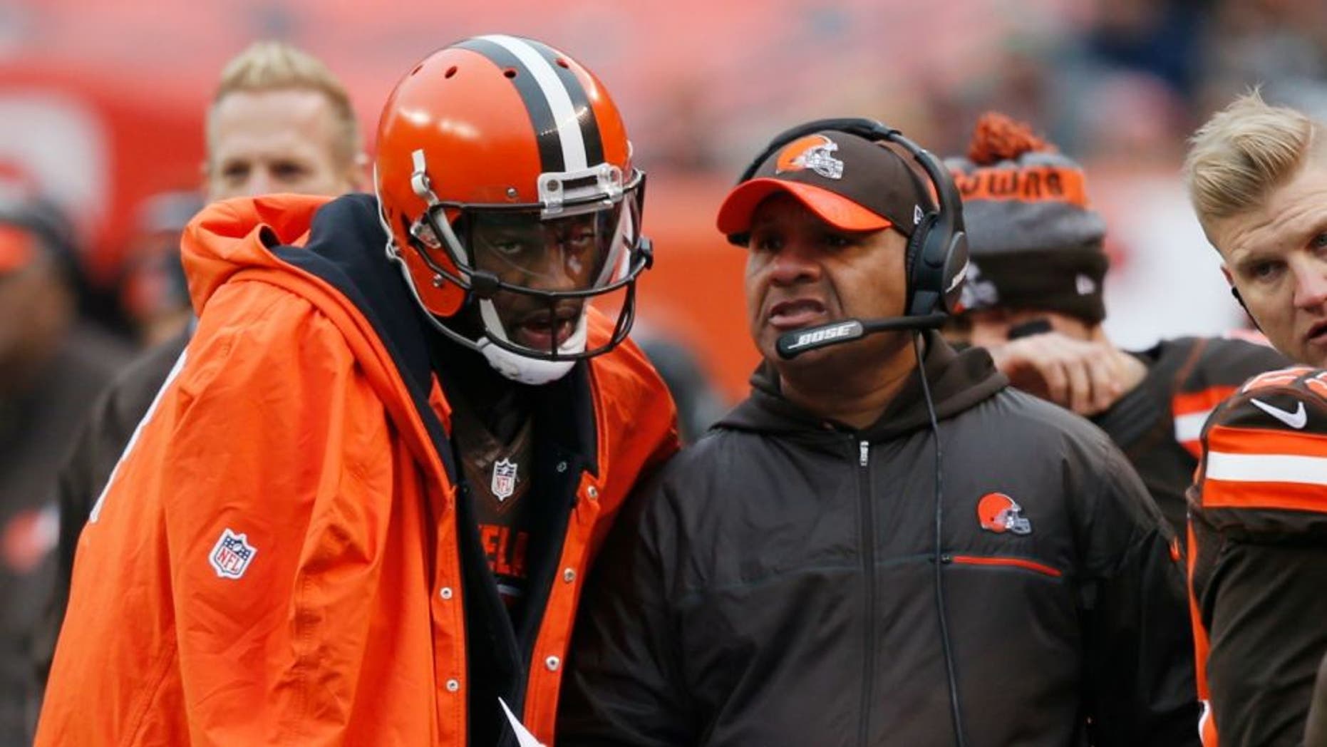 Cleveland Browns head coach Hue Jackson, right, talks with quarterback Robert Griffin III in the first half of an NFL football game against the San Diego Chargers, Saturday, Dec. 24, 2016, in Cleveland. (AP Photo/Ron Schwane)