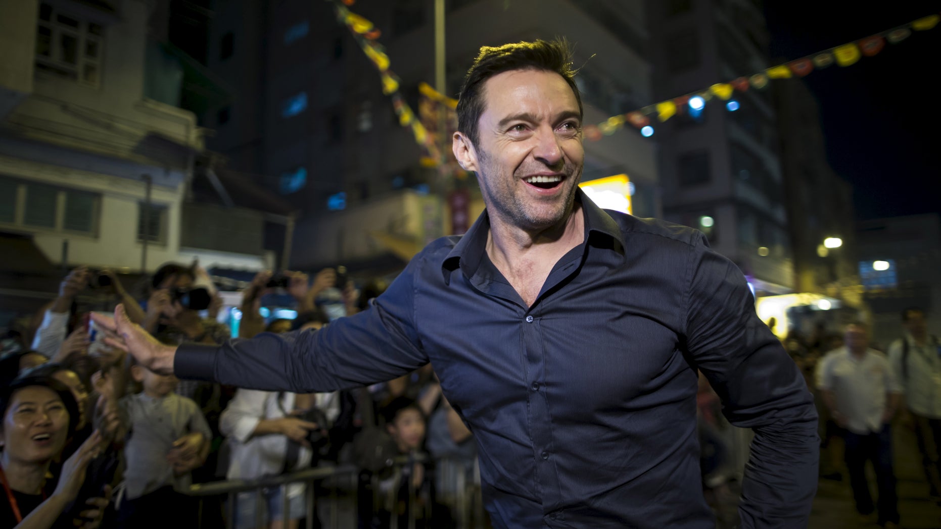Australian actor Hugh Jackman waves to fans at the "Tai Hang Fire Dragon Dance" event to celebrate the Mid-Autumn Festival during a trip to promote his latest film "Pan" in Hong Kong, China September 28, 2015.
HKTB2016
REUTERS/Tyrone Siu - RTSG9H9