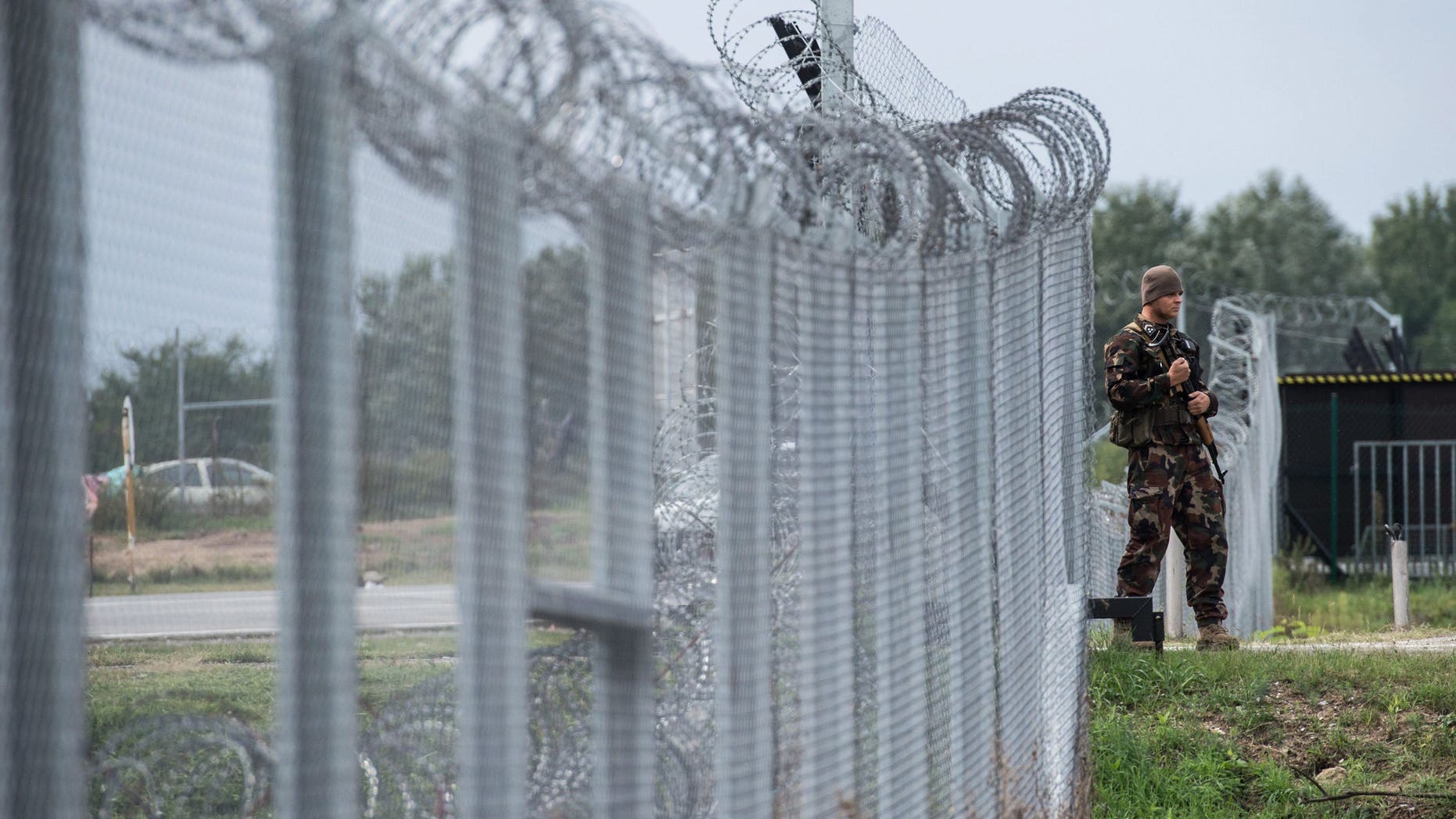 A Hungarian soldier patrols at the transit zone at Hungary's southern border with Serbia.