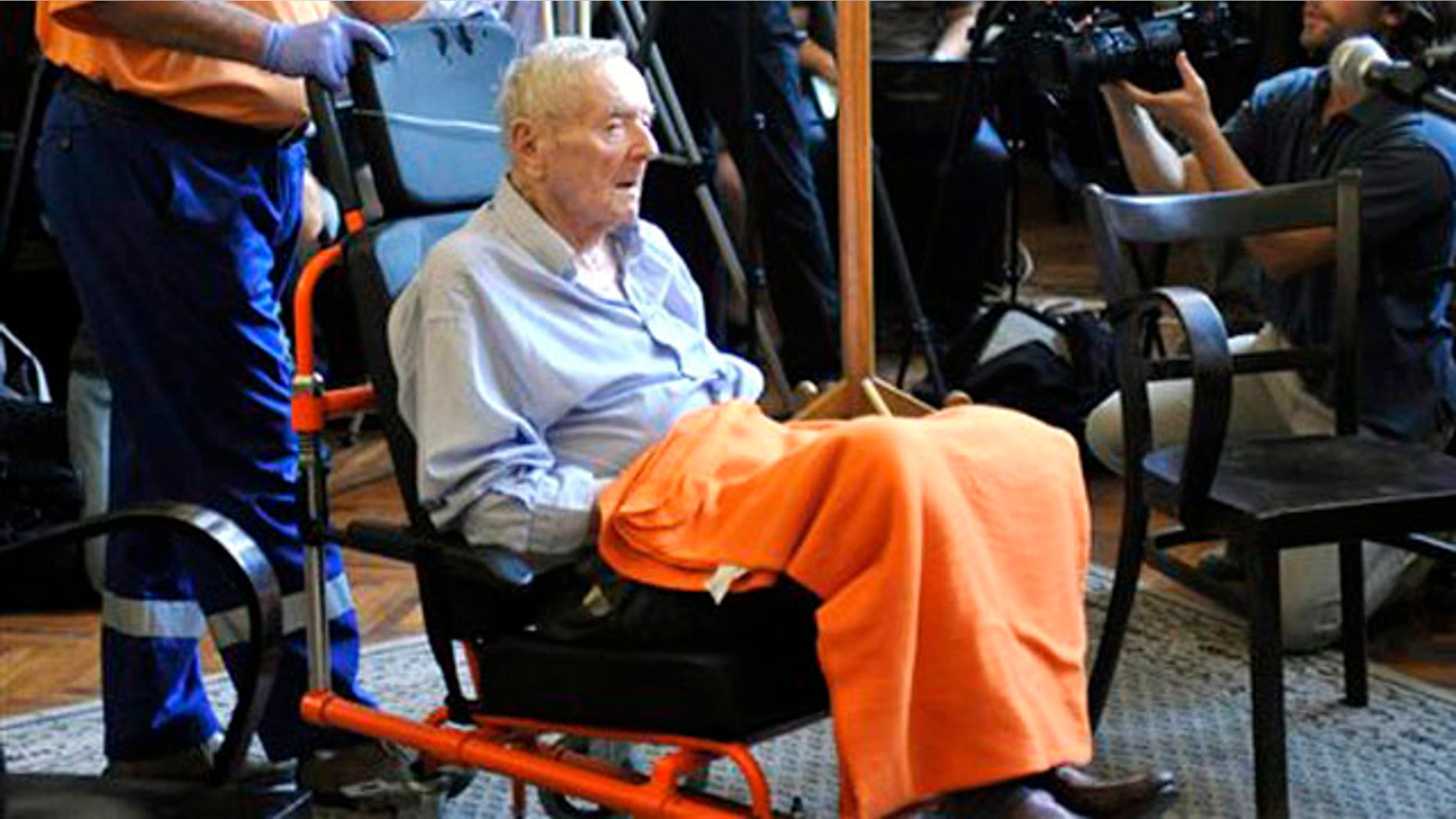 Former Hungarian gendarme captain Sandor Kepiro sits in a wheelchair in the courtroom prior to the verdict in the Municipal Court of Budapest, Hungary, Monday, July 18, 2011.
