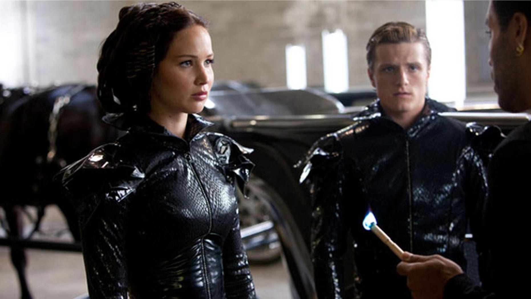 "Hunger Games" heroine Katniss Everdeen and fellow tribute Peeta Mellark wait to be lit on fire before making their fiery public debut.