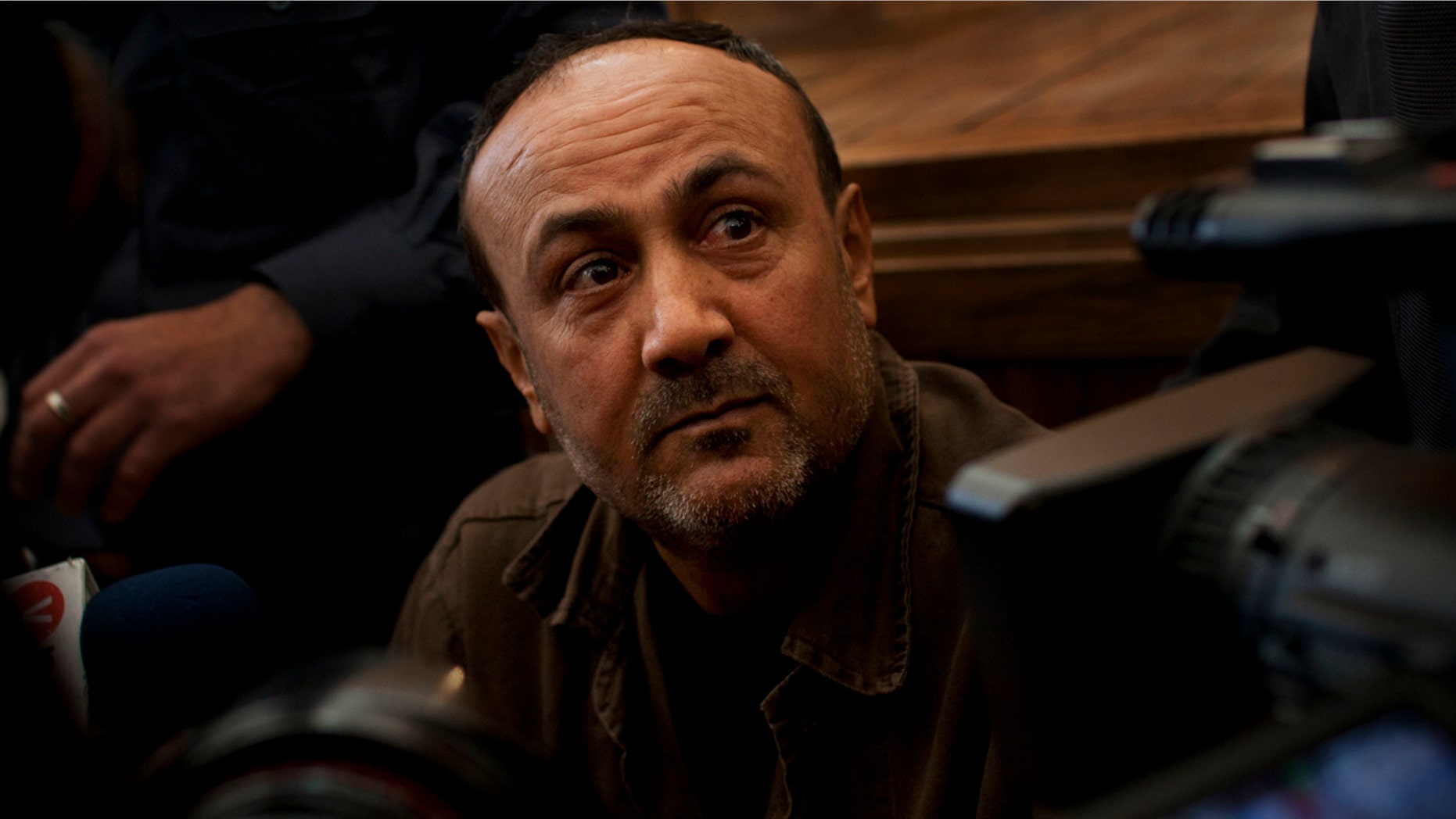 FILE - In this Jan. 25, 2012, file photo, senior Fatah leader Marwan Barghouti appears at Jerusalem's court. Israel's Prison Service released footage on Sunday, May 7, 2017, that it says shows Barghouti, the leader of a mass Palestinian hunger strike, breaking his fast, a claim dismissed by the Palestinians as an attempt to undermine the open-ended strike, now in its 21st day. (AP Photo/Bernat Armangue, File)